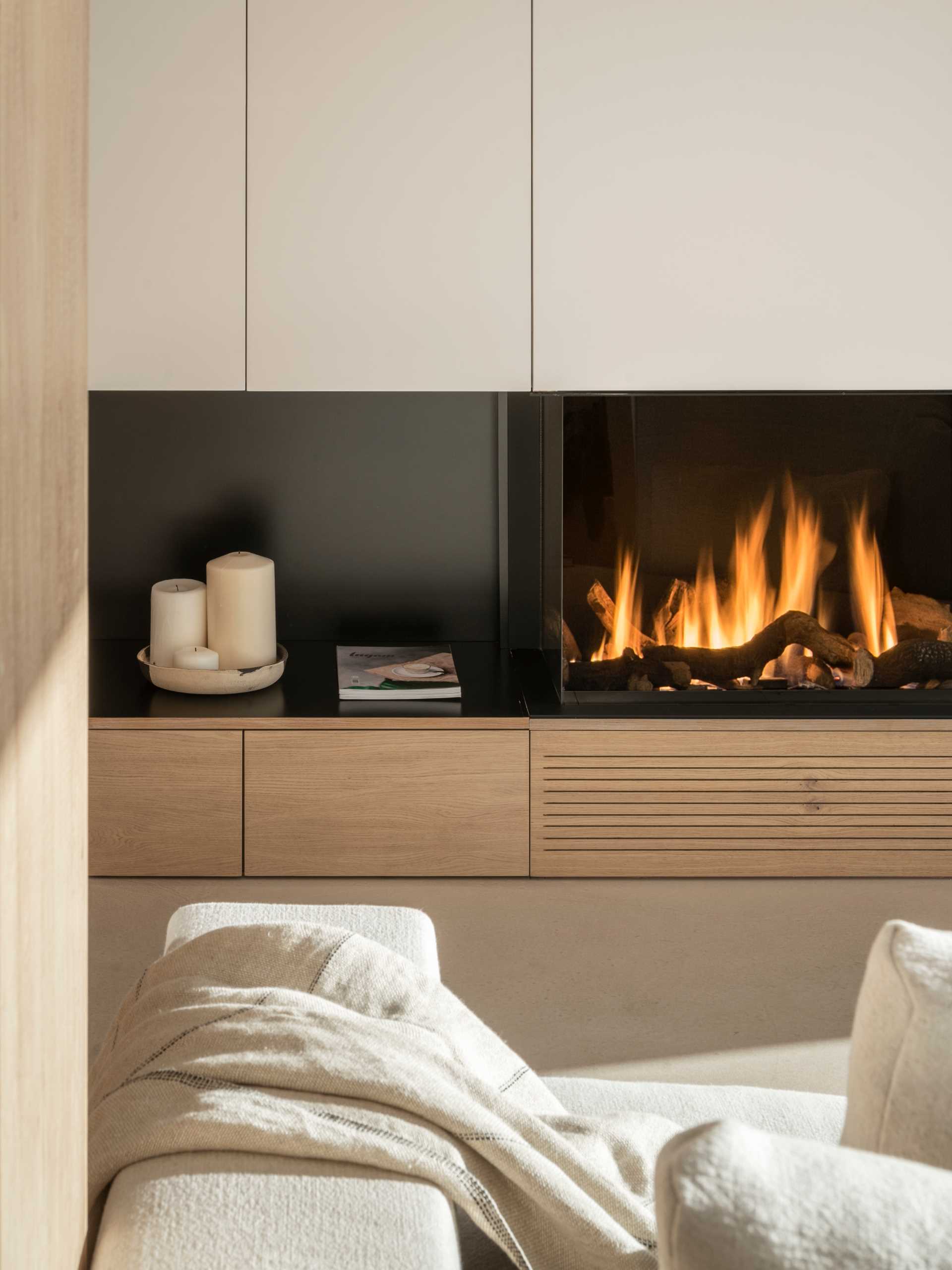 A modern living room with a black fireplace.