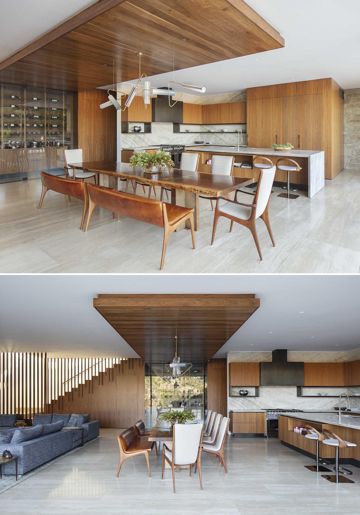 This modern open plan dining area is  defined by a wood ceiling accent and the large complementing live edge wood table.