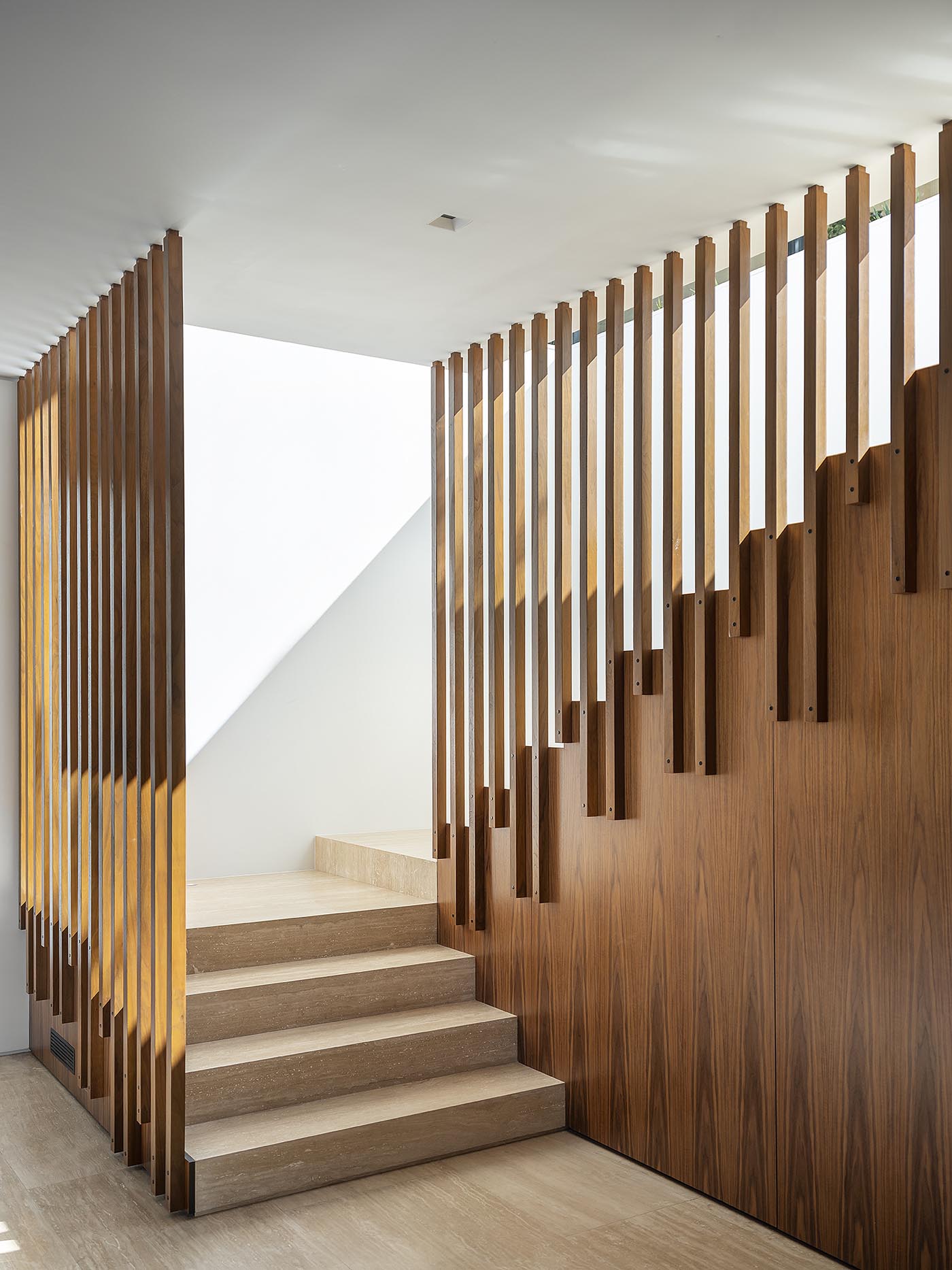 A modern staircase with wood slat accents.