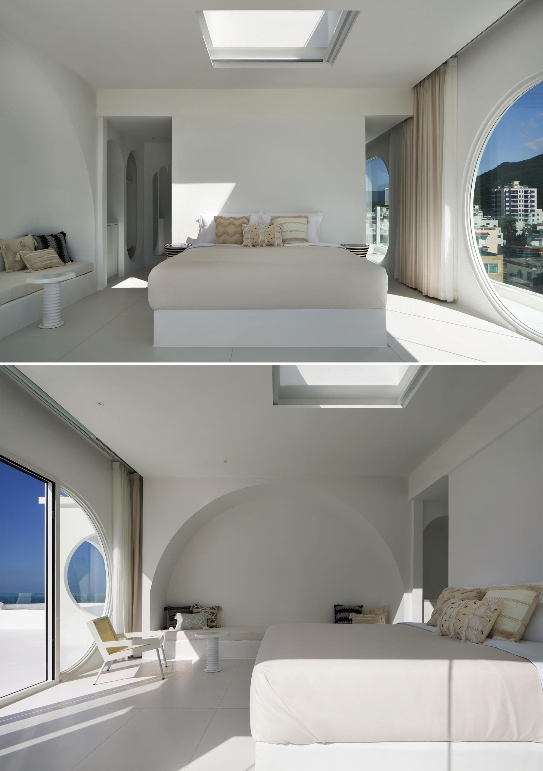 A modern white hotel room with a large round window.