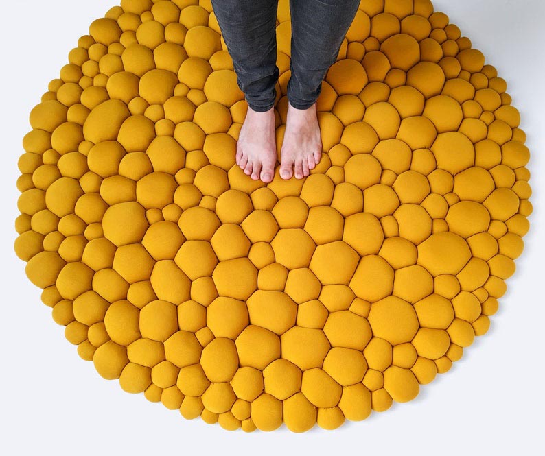 A modern yellow bubbly rug.