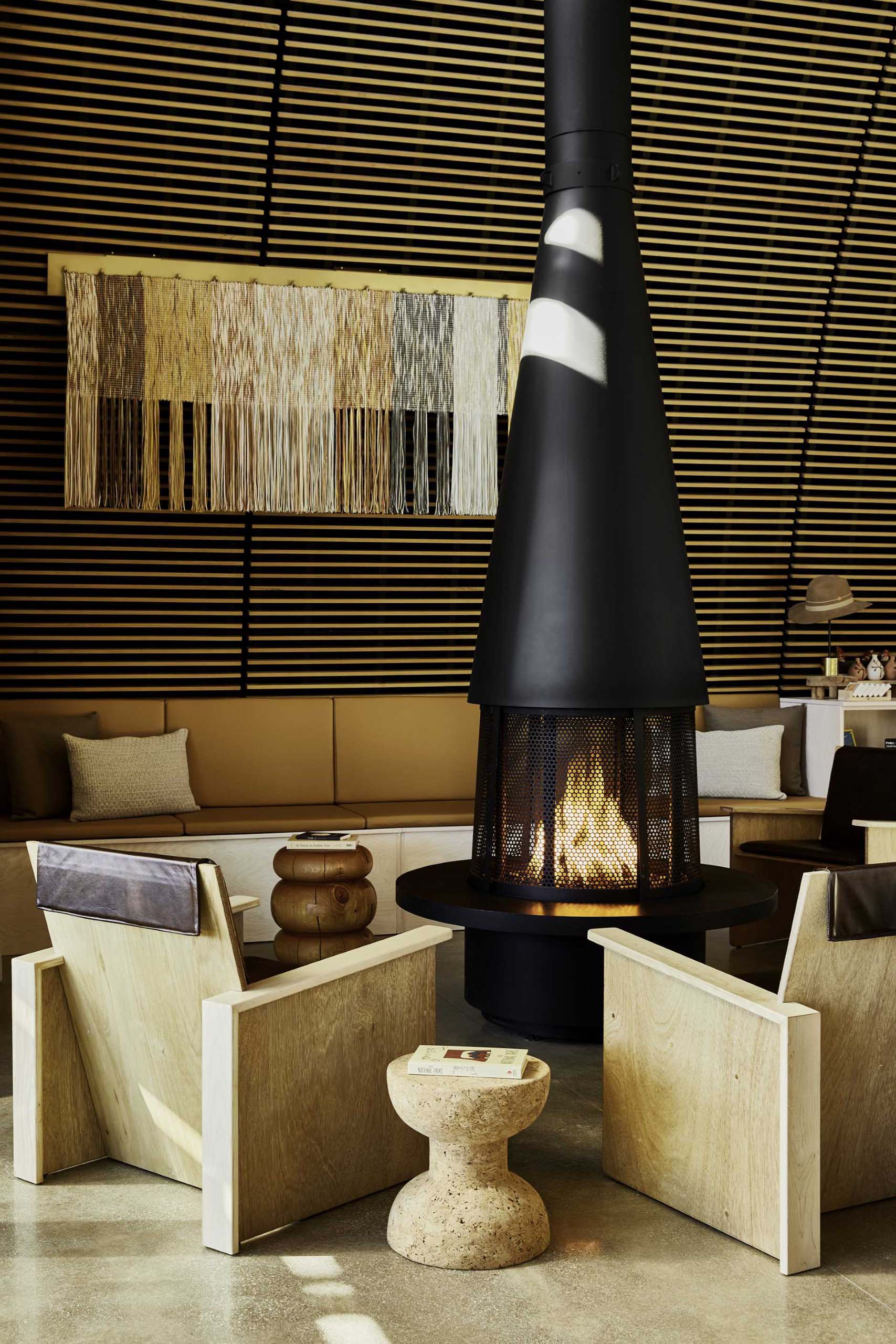 A modern black fireplace and surrounding seating within a clubhouse.