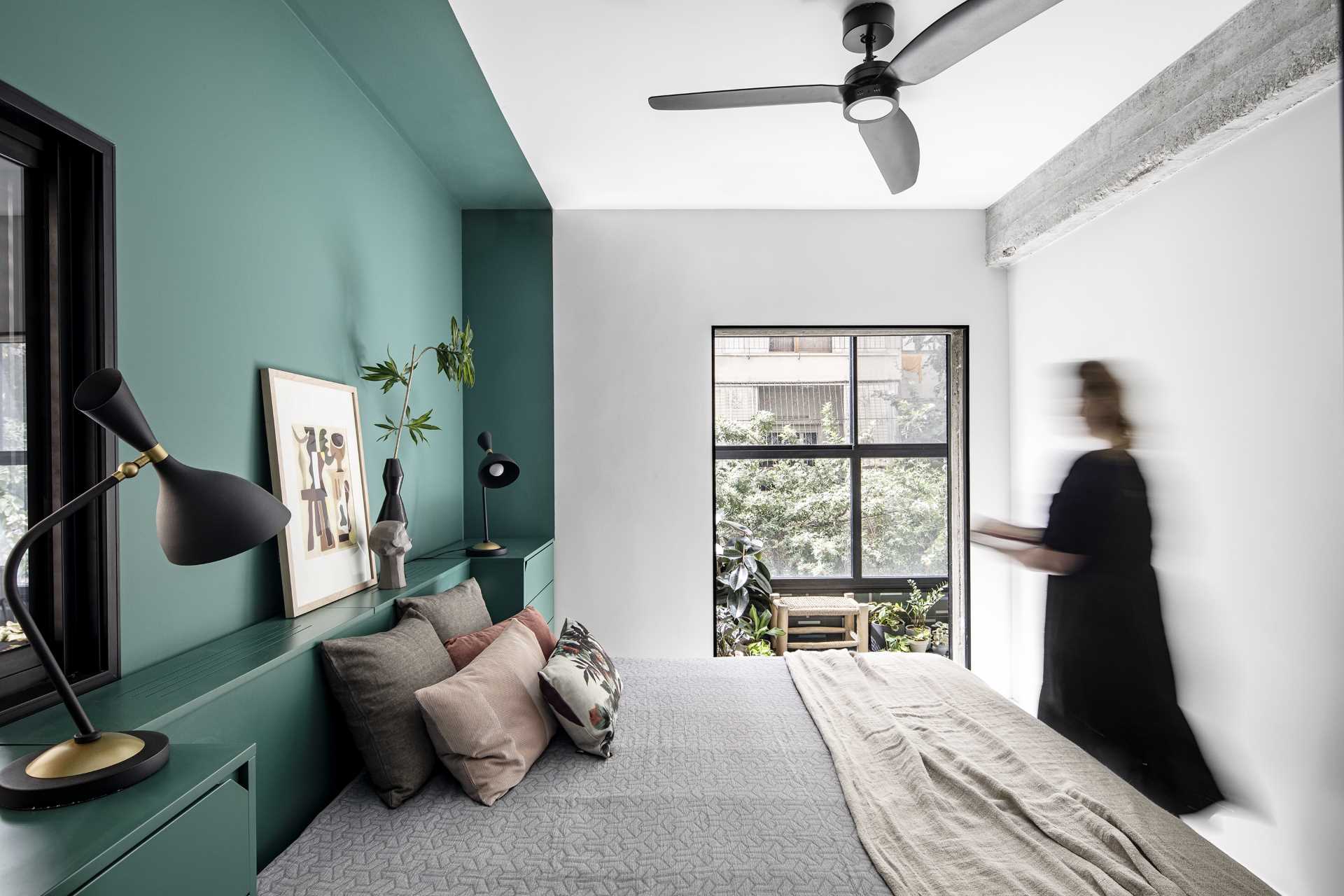 A Green Accent Wall Frames The Bed And