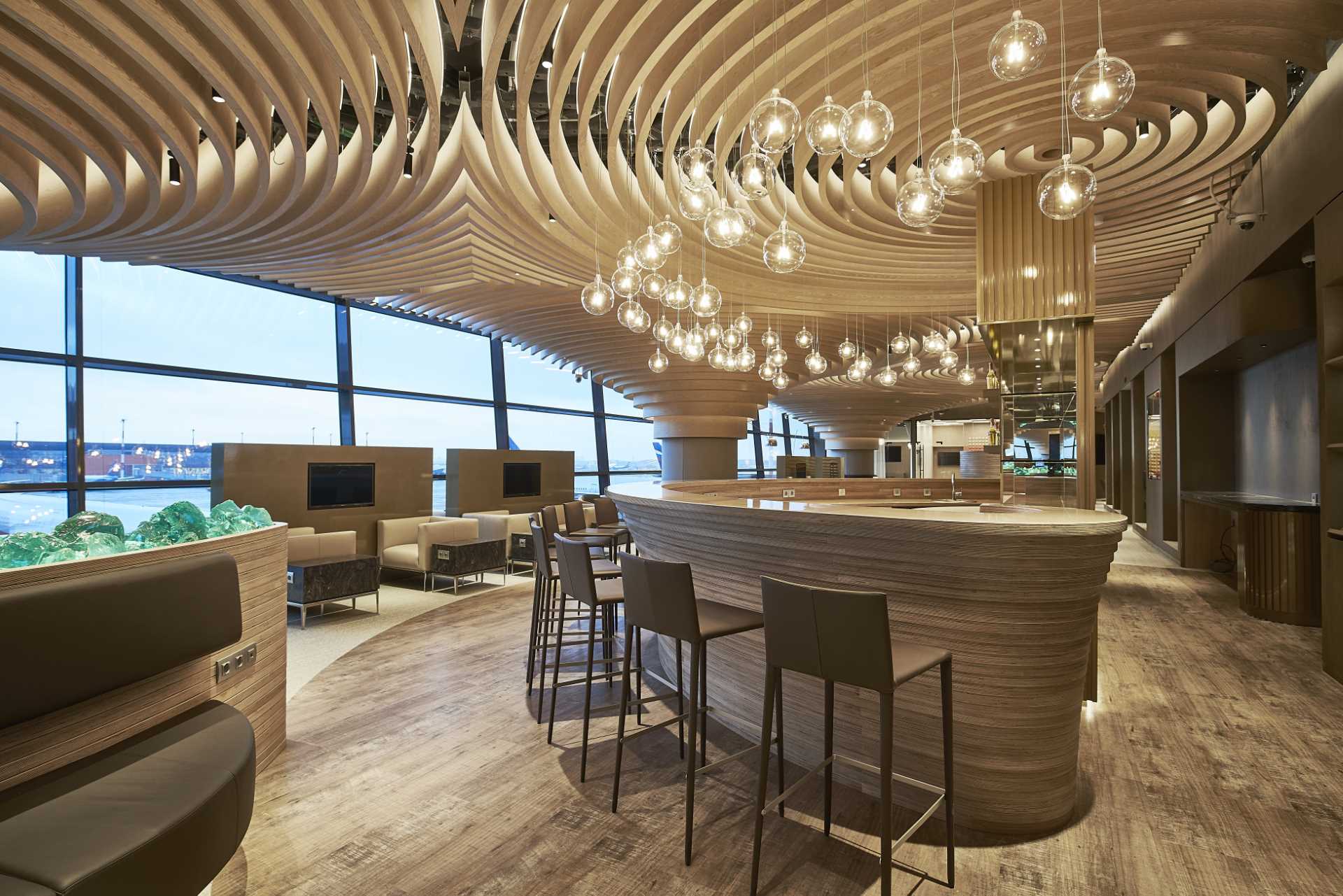 Circular ceiling elements repeat over the ceiling of this airport lounge.