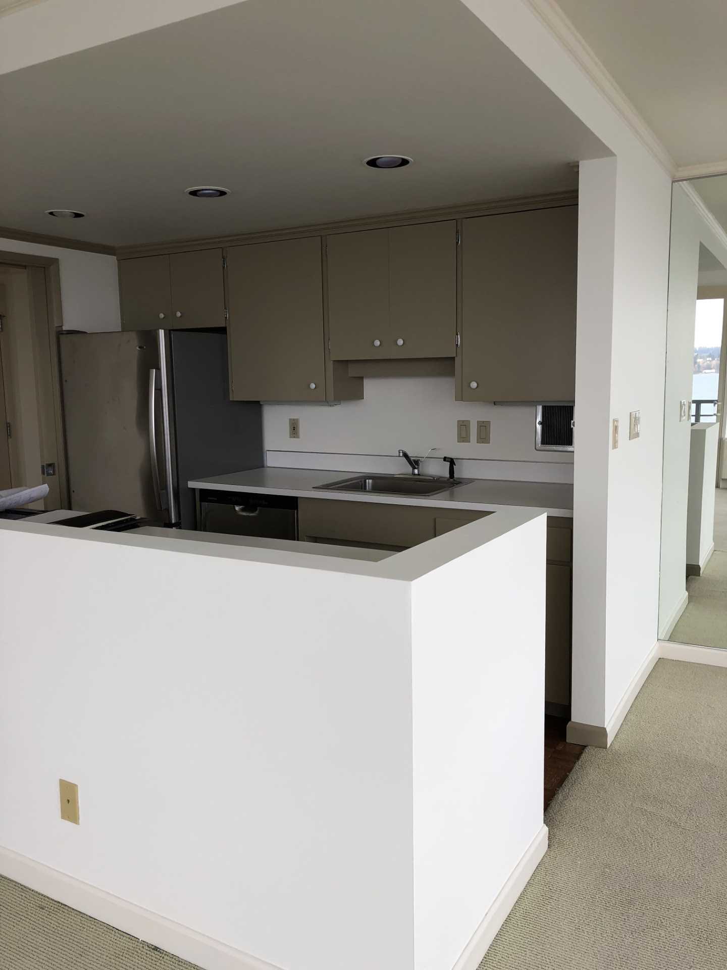 BEFORE - A dated mid-century modern kitchen.