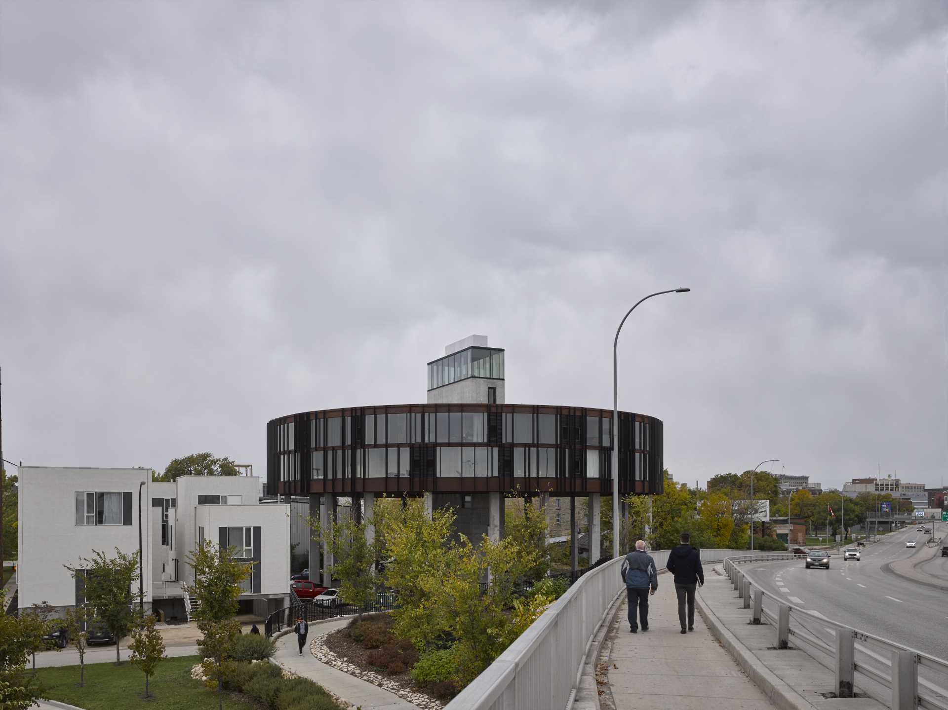 A round building with two levels of wedge-shaped apartments.