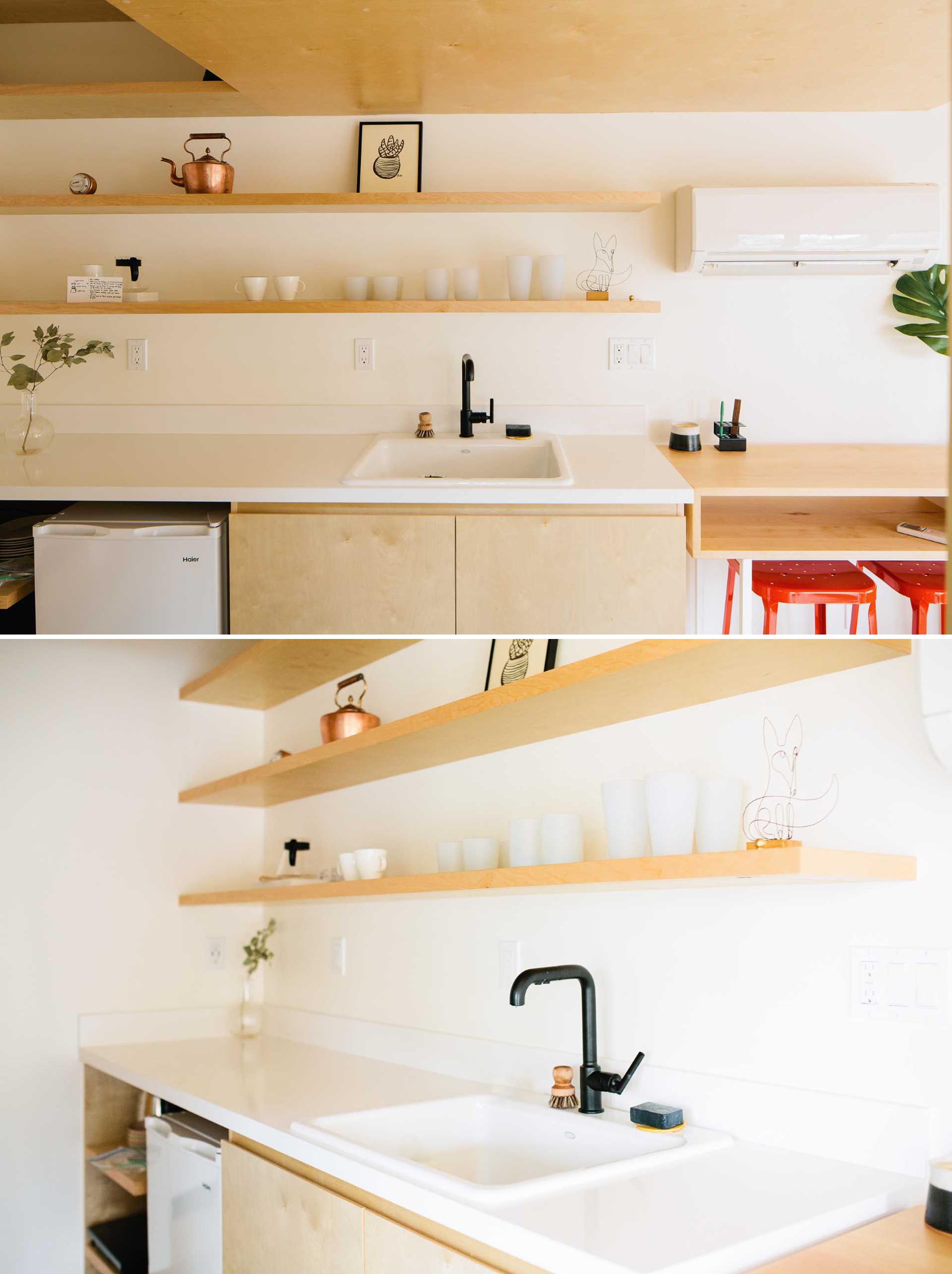 In this small kitchen, floating wood shelves have been added for storage, while a white countertop helps to keep the space bright.