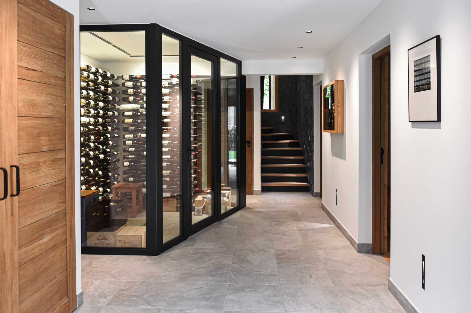 A modern home with a glass enclosed wine cellar.