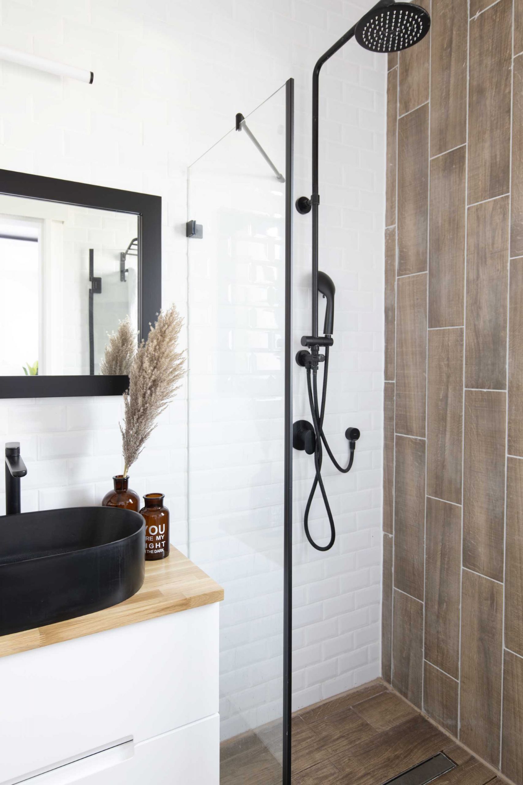 A modern bathroom with wood accents.