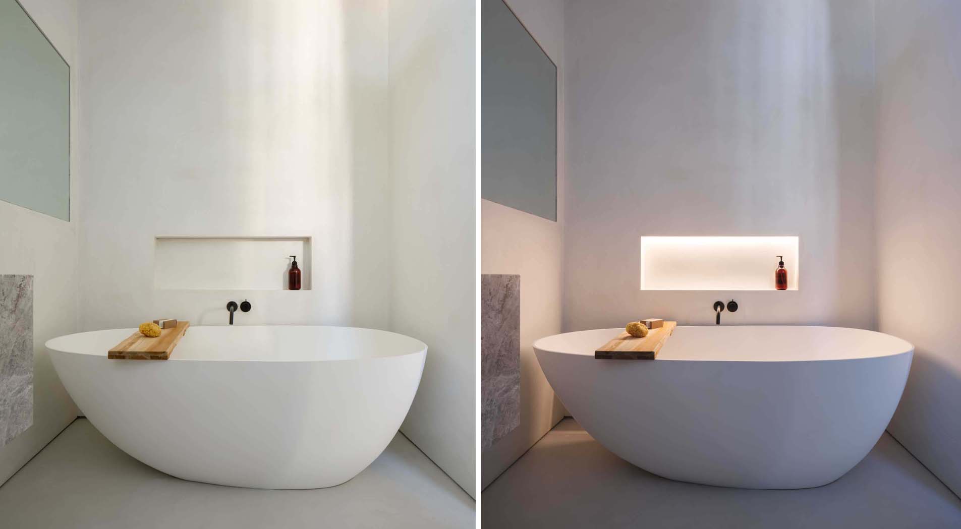 Modern bathroom with freestanding bathtub, modern taps and blue LED ambient  lighting Stock Photo