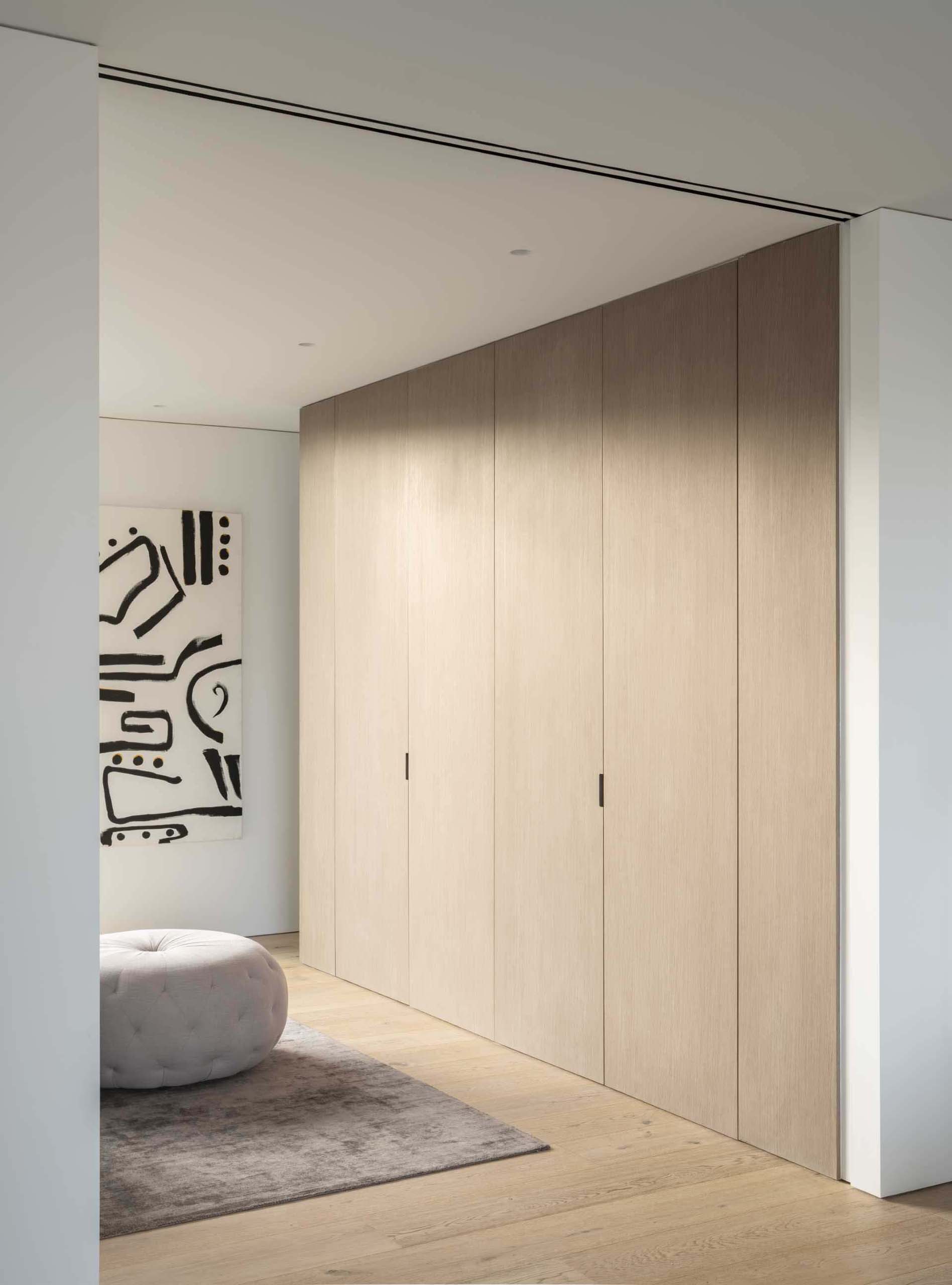 A modern wood closet with flush doors.