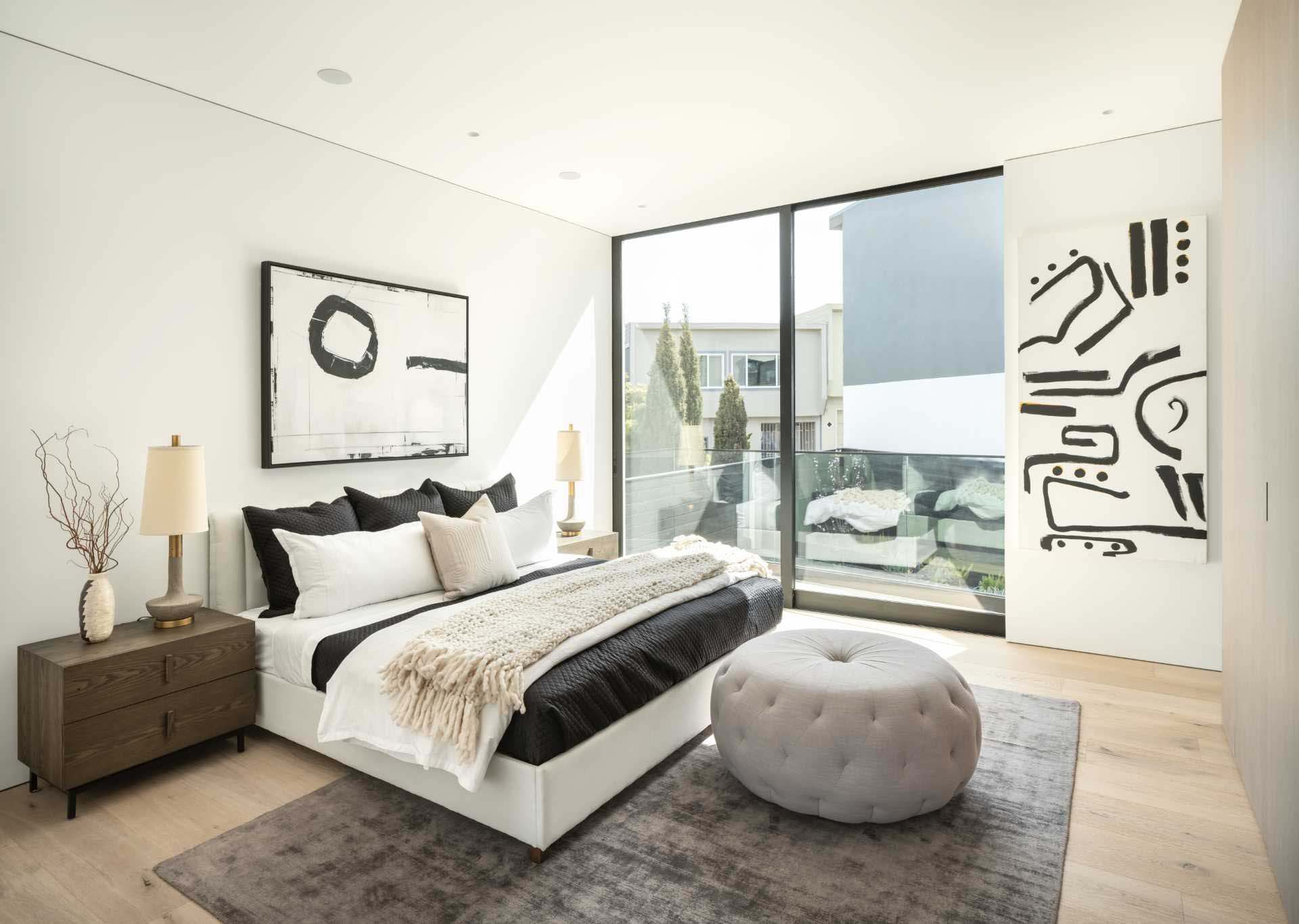 A modern bedroom with black and white artwork.