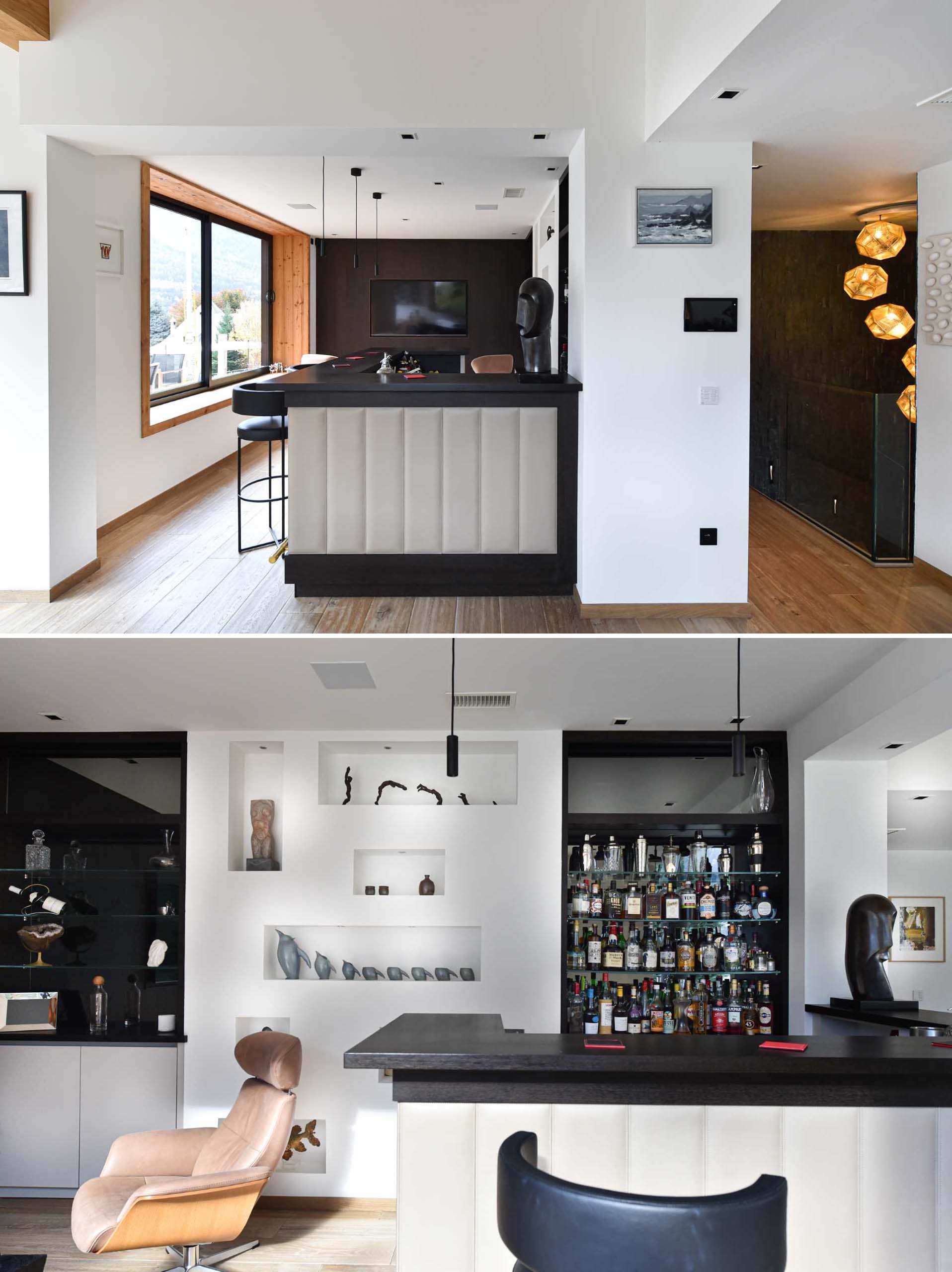 A modern home bar with large windows and a dark accent wall that allows the TV to somewhat blend into the background.