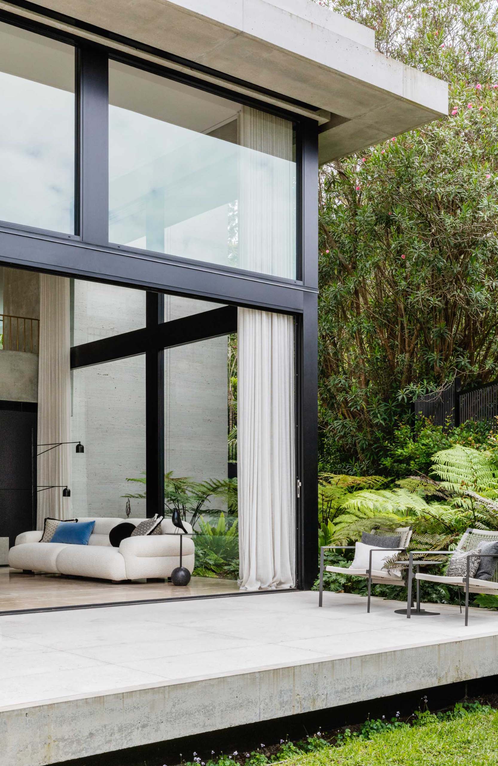 A modern house with a floating concrete deck.