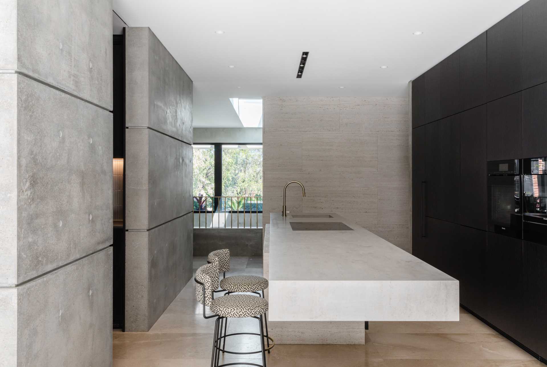 A modern kitchen with a large cantilevered island.