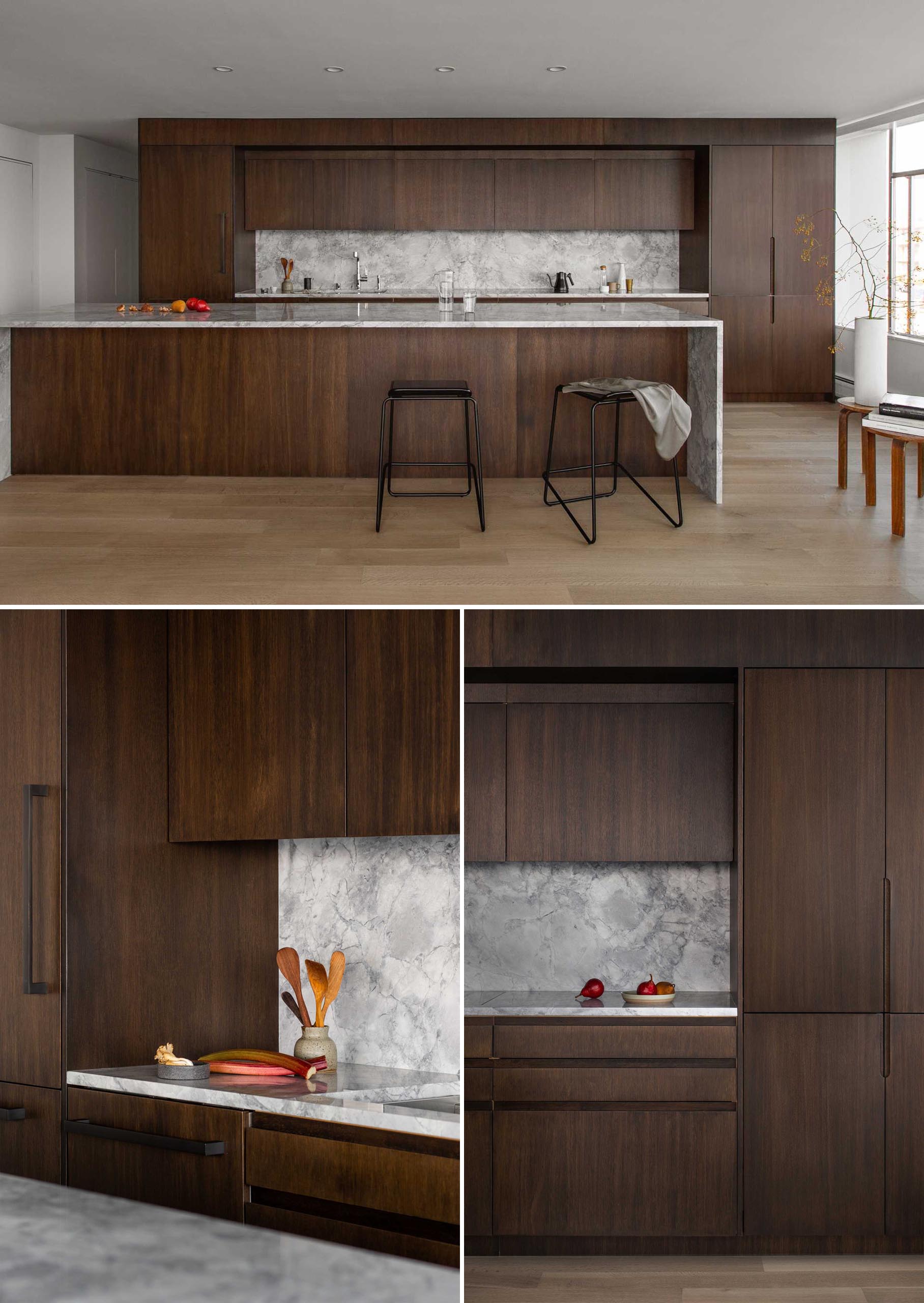 This modern dark wood kitchen includes solid panel rift sawn stained white oak panels with tactile finger pulls, giving a warm and tactile intimacy to the casework.