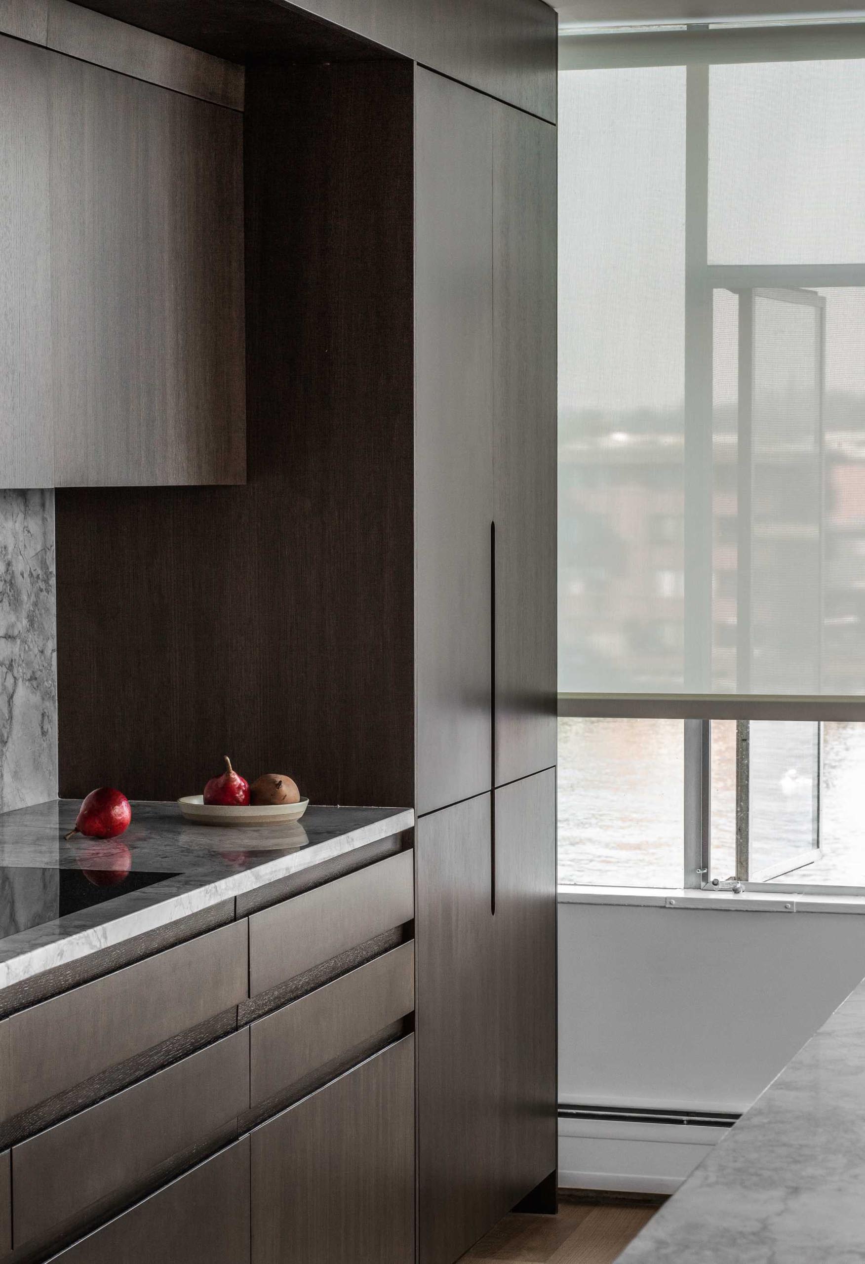 A modern kitchen with dark stained wood cabinets.