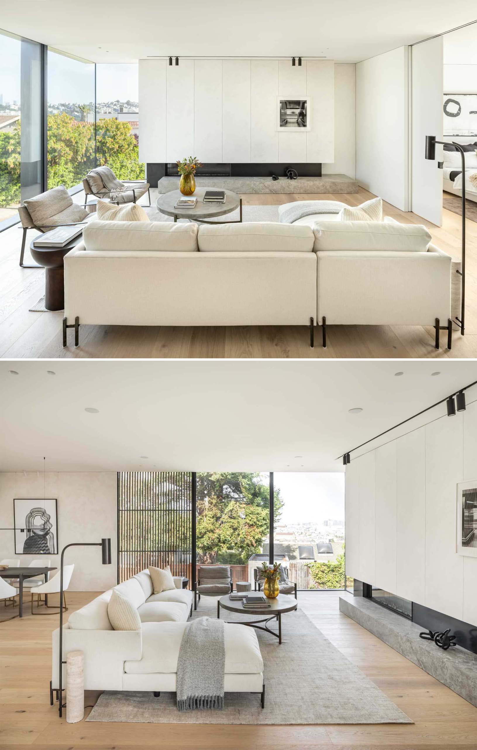 A modern living room with light colored furniture, and European wide plank oak floors.