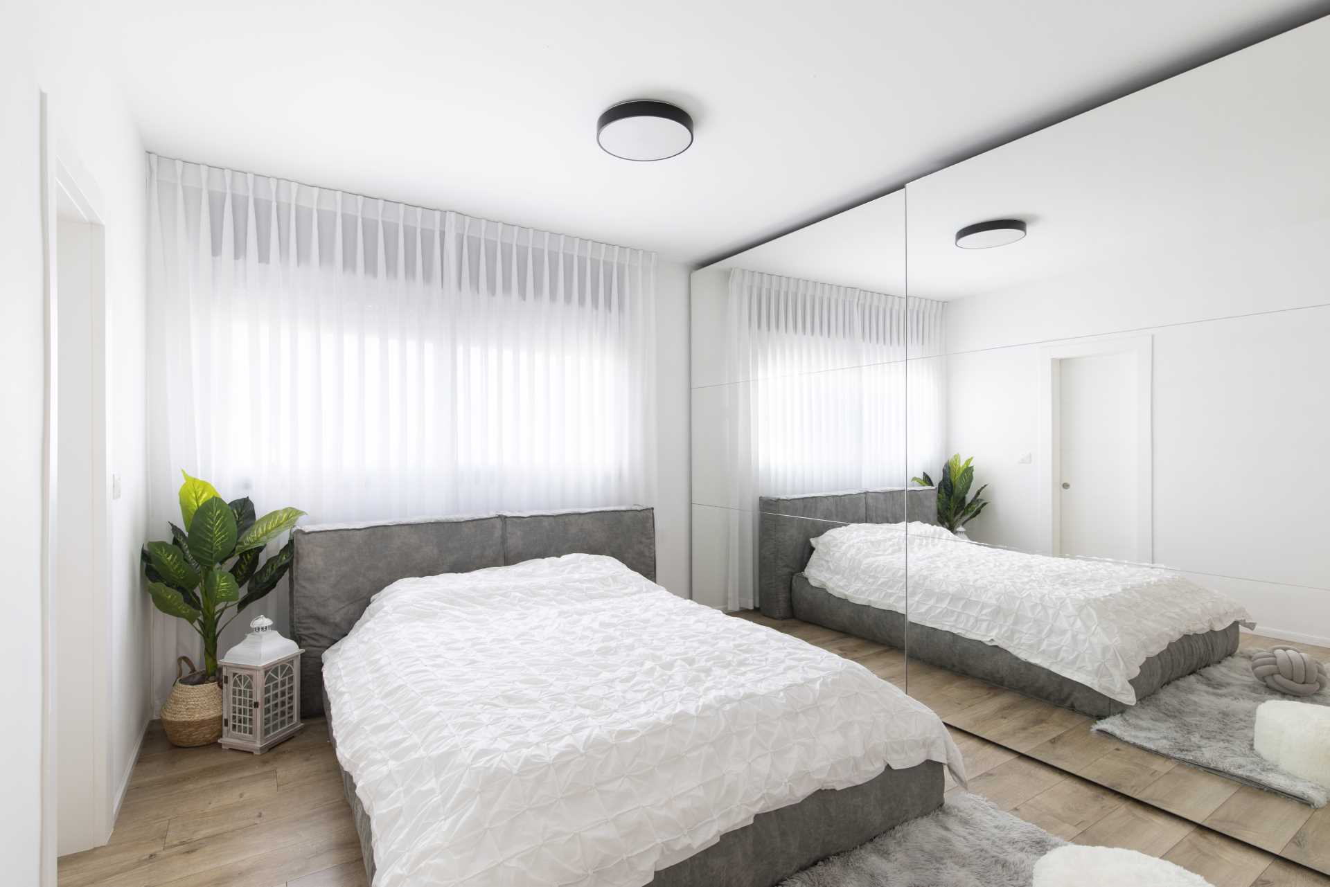 This main bedroom includes a mirrored wardrobe making the room appear larger than it is.