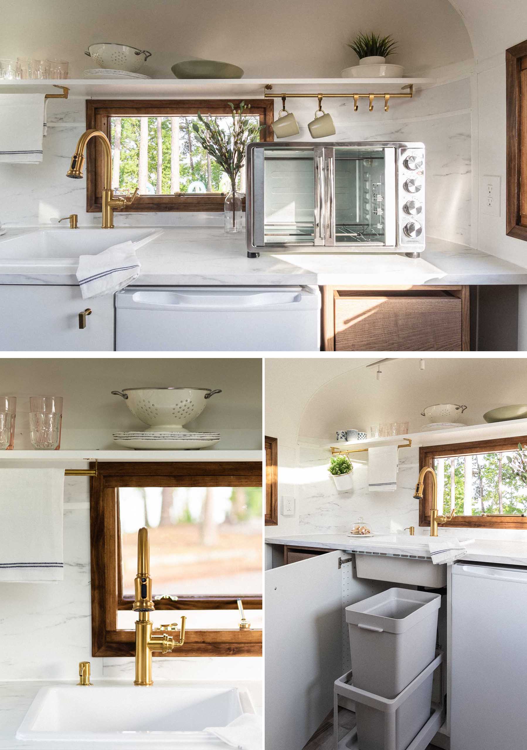 The remodeled kitchen of this vintage travel trailer includes wood cabinetry, a shelf, and a light colored countertop. There's also an induction cooktop and convection oven.