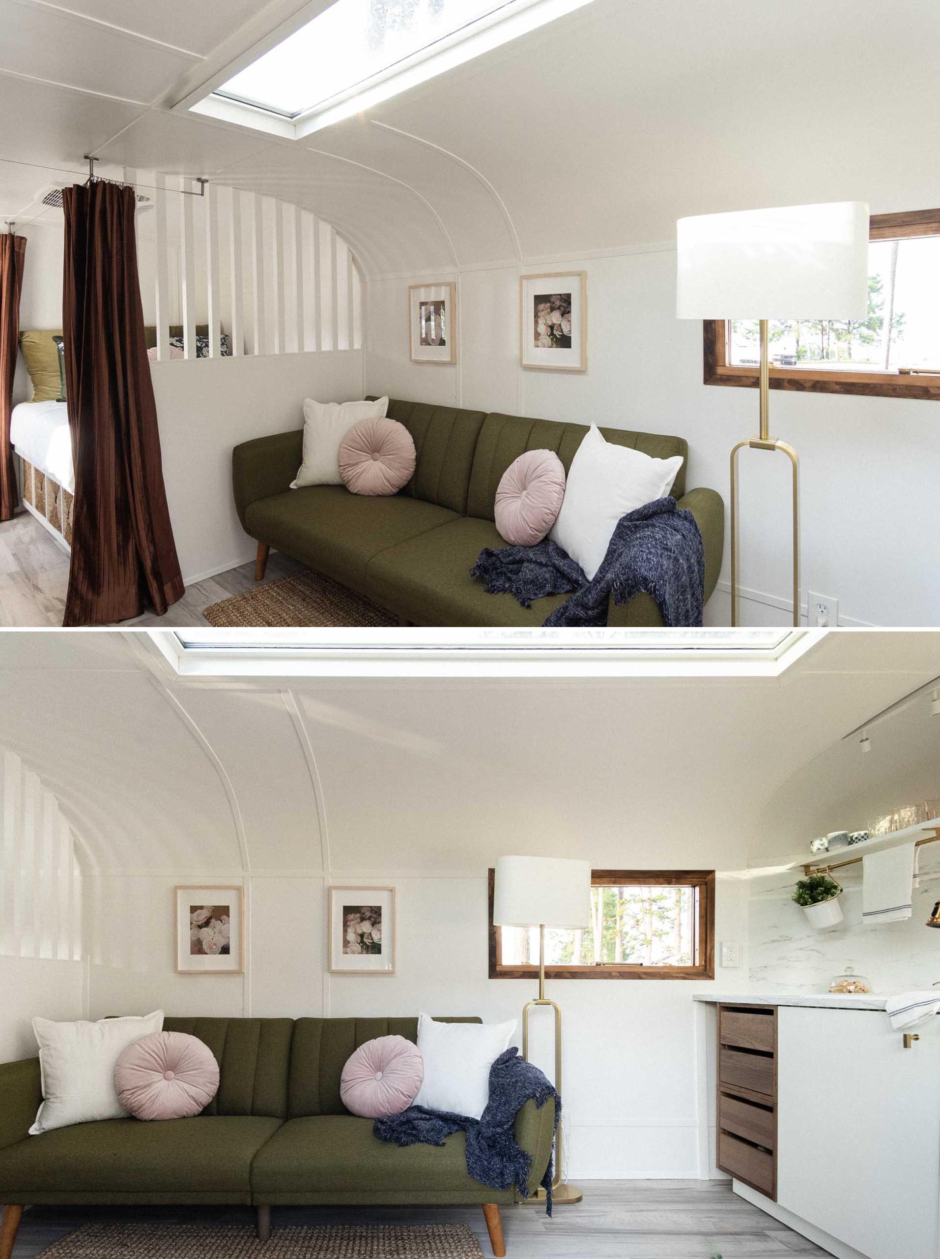 The living room of this remodeled vintage travel trailer is small but functional, with a sofa that transforms into a bed, allowing for two additional people to sleep in the trailer.