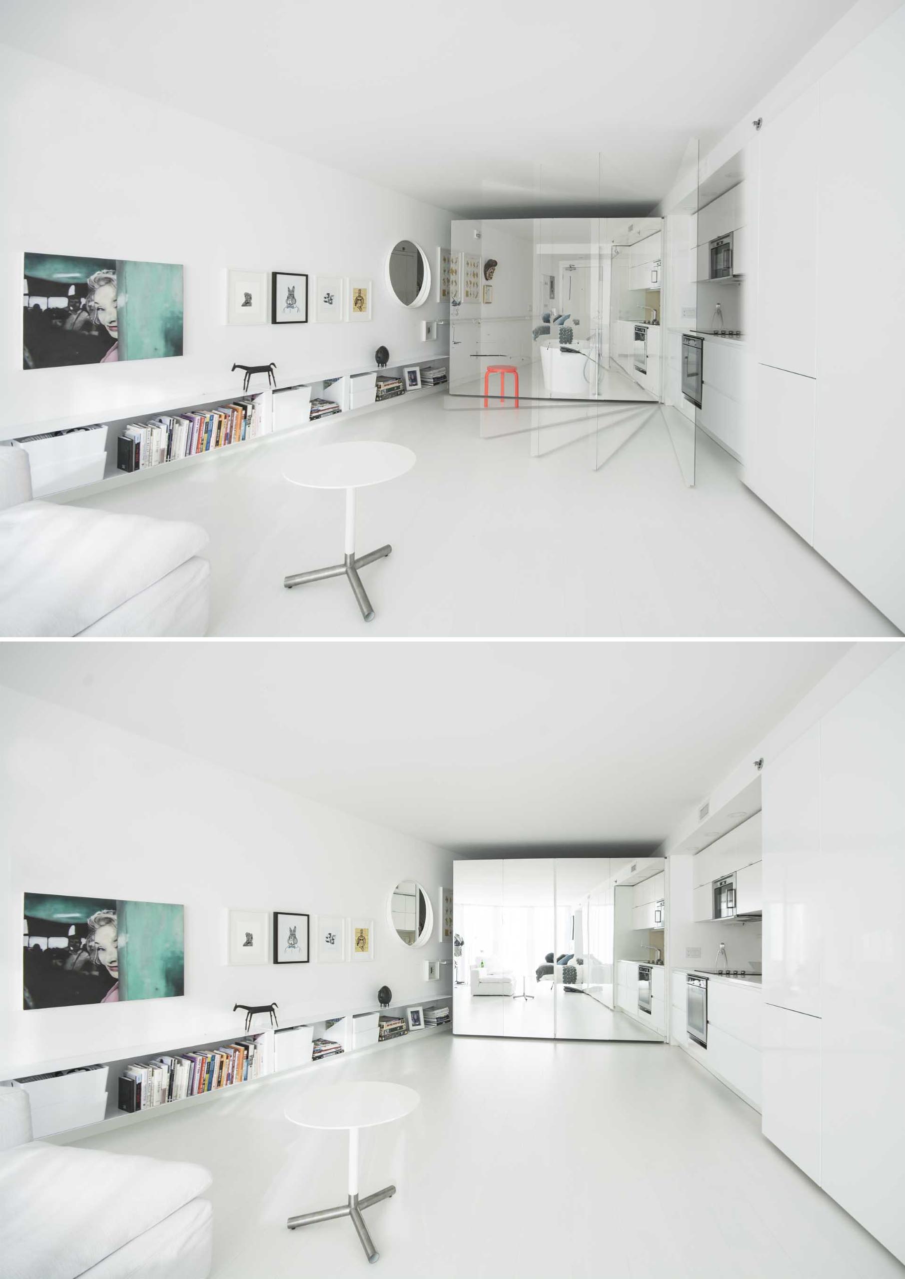 A small white apartment is shaped like a wedge, and has a hidden kitchen within the wall.