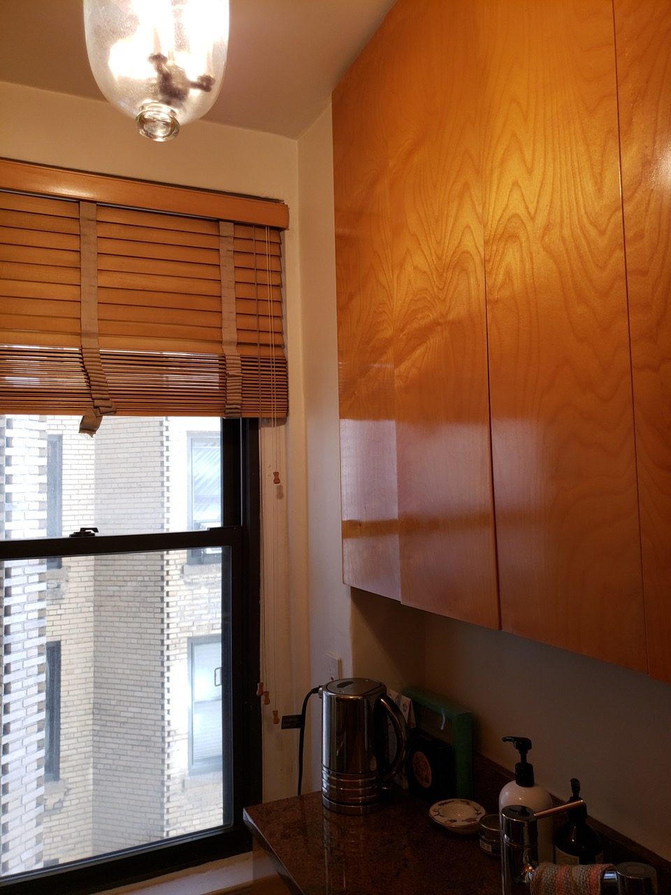 Before Photo - the remodel of a dated galley kitchen with wood cabinets.