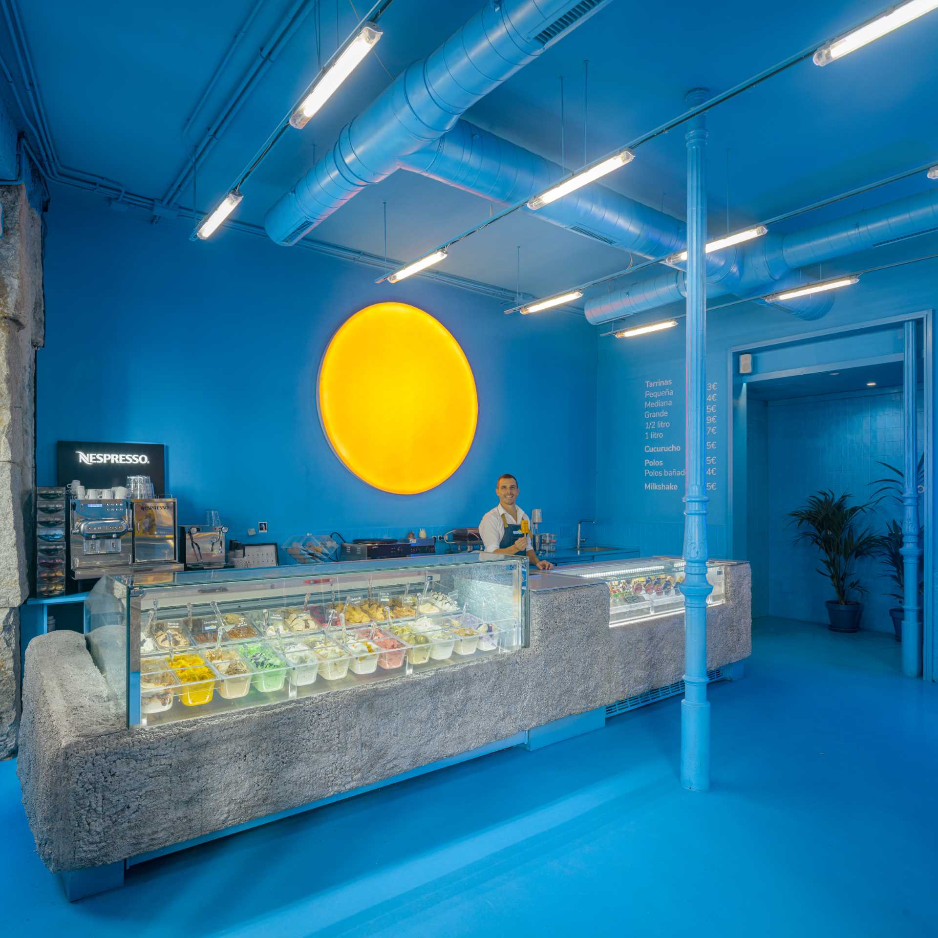 Named 'BRANDO', this modern ice cream shop has a bold and bright blue interior that creates a fun and vibrant atmosphere.