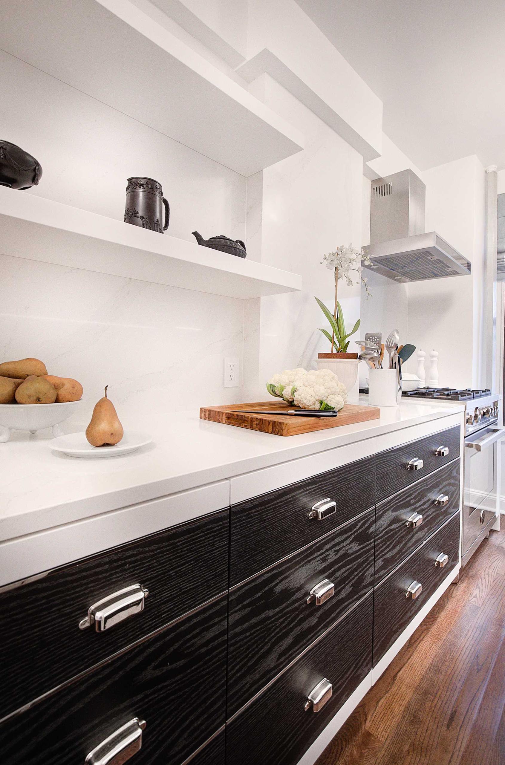 This kitchen includes polished nickel inlay accents that create the look of drawers throughout, even on cabinet doors.