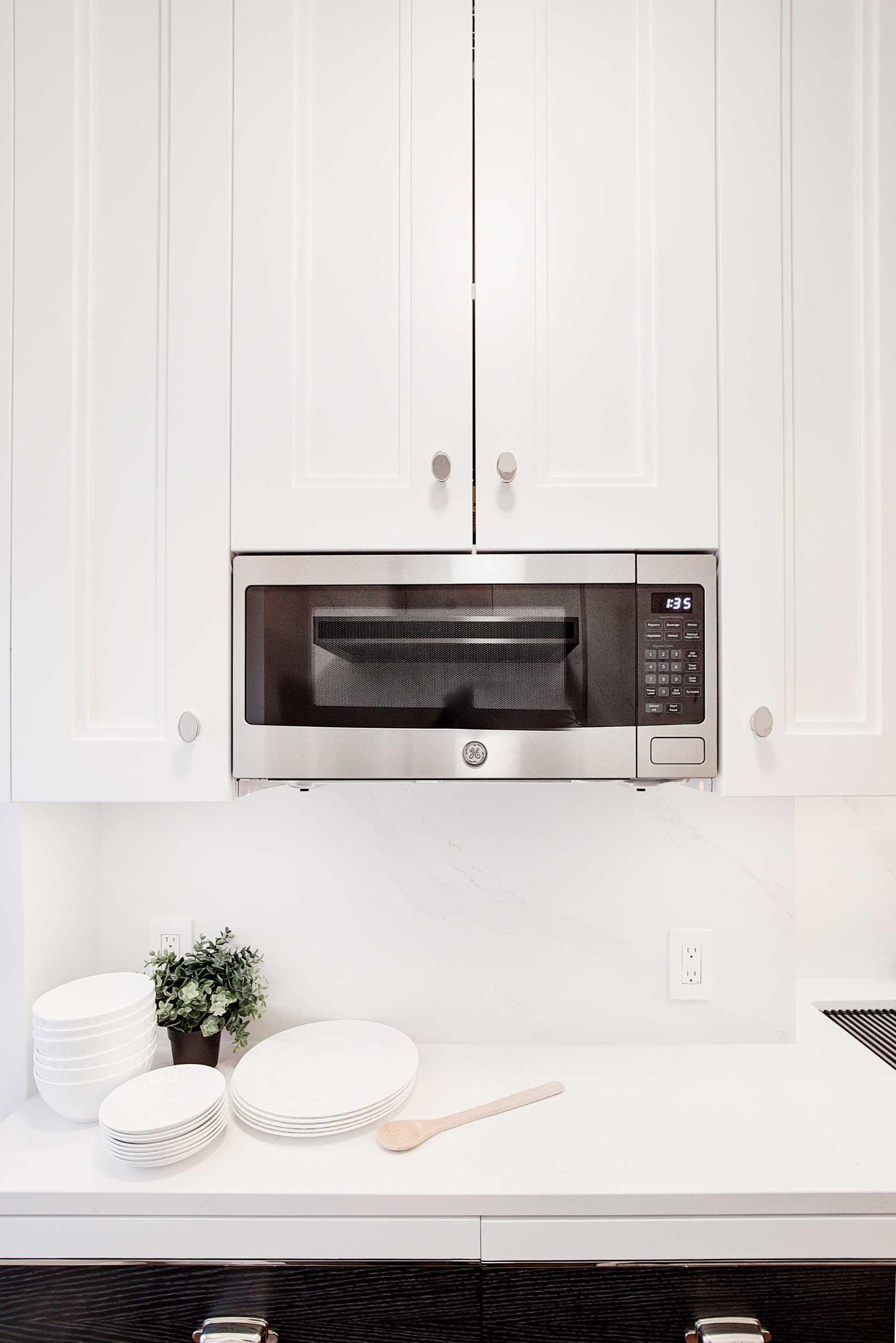 A contemporary kitchen with a built-in microwave.