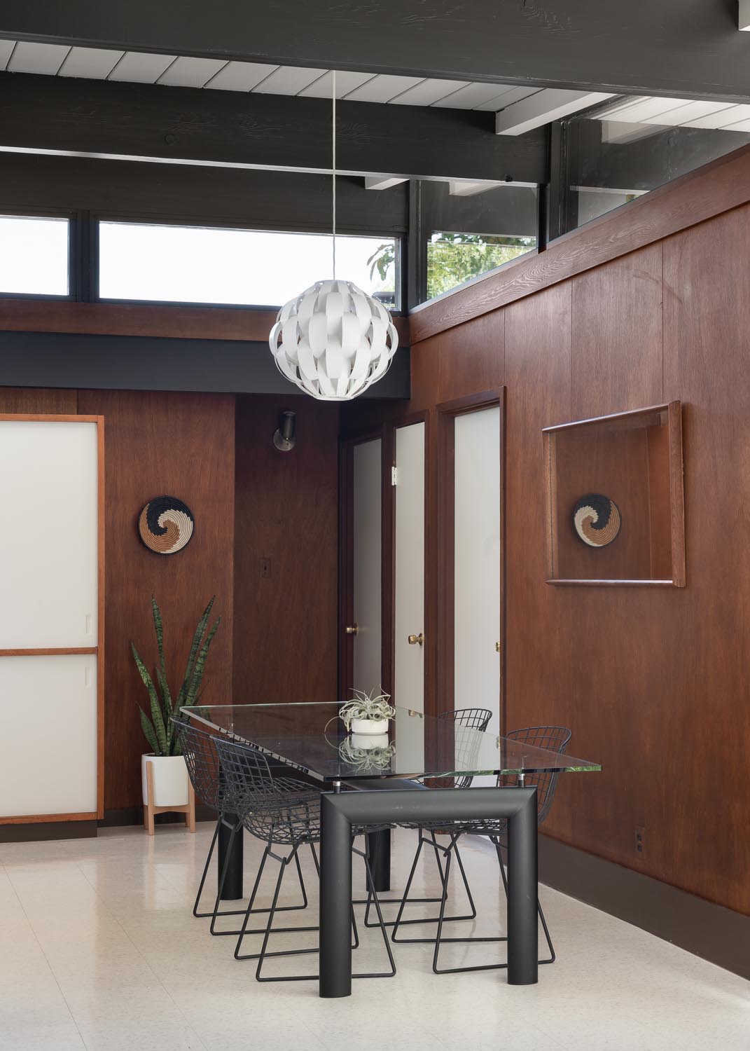 The restoration of an Eichler home included keeping the wood panel walls in the dining area.