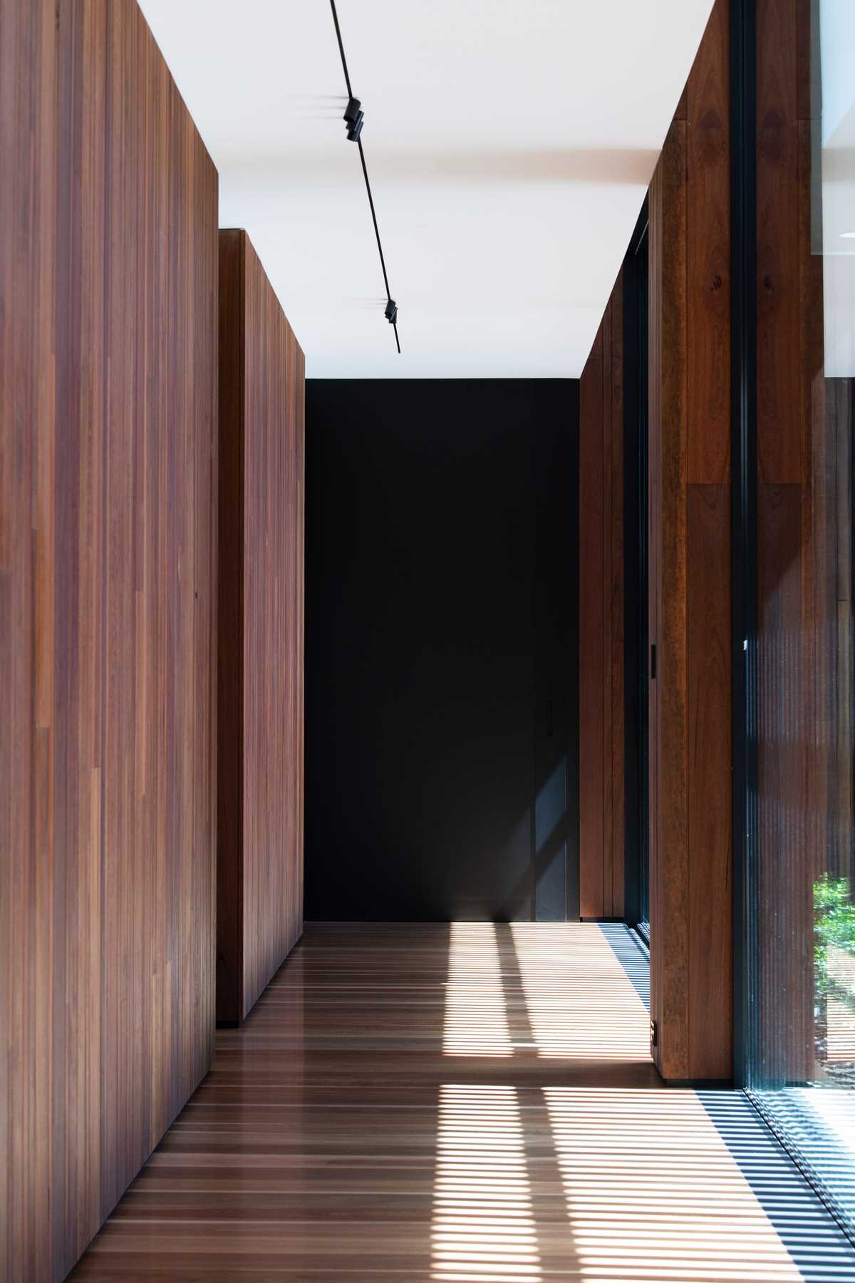 A modern hallway with wood floors.