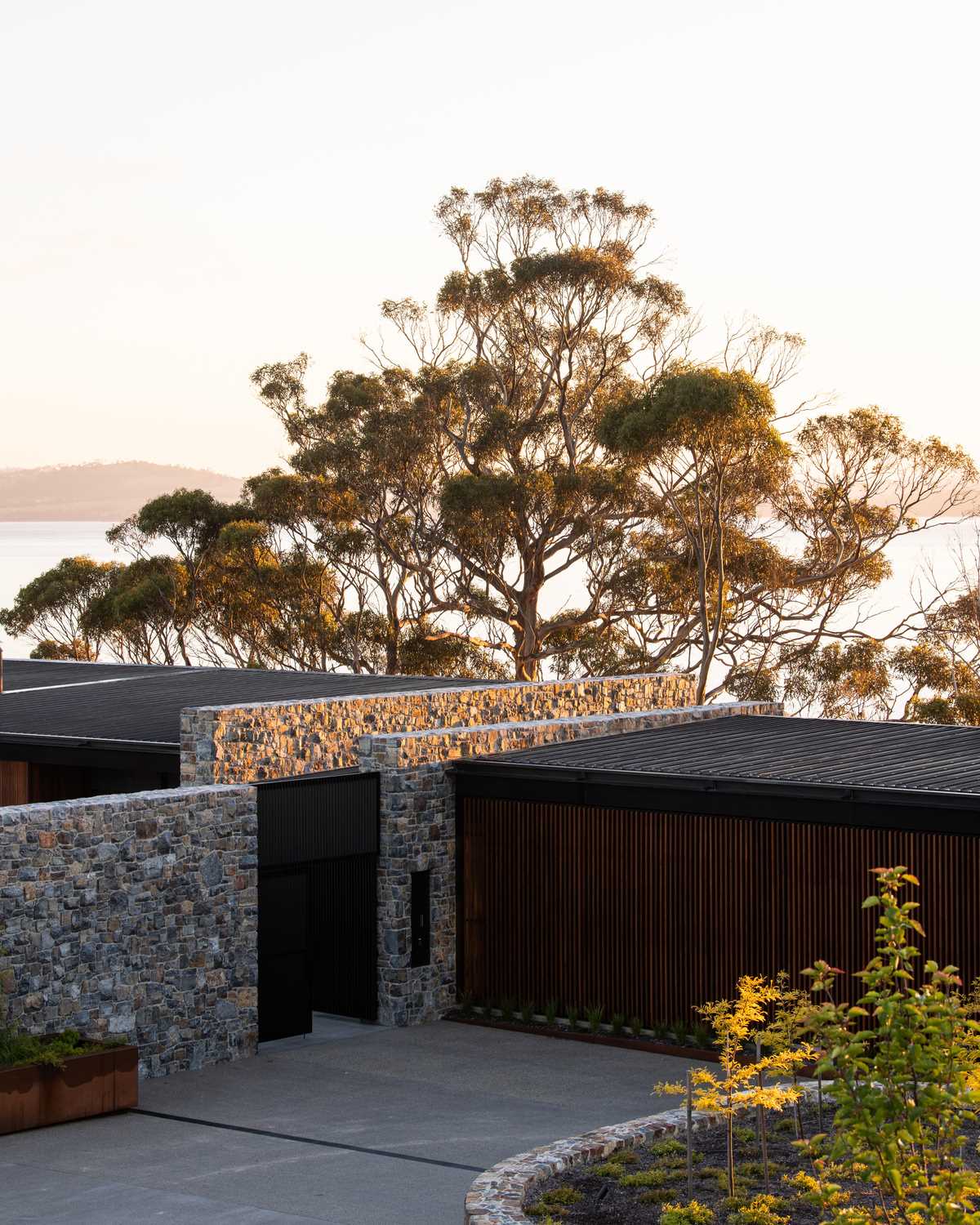A modern house with mudstone walls and wood accents.