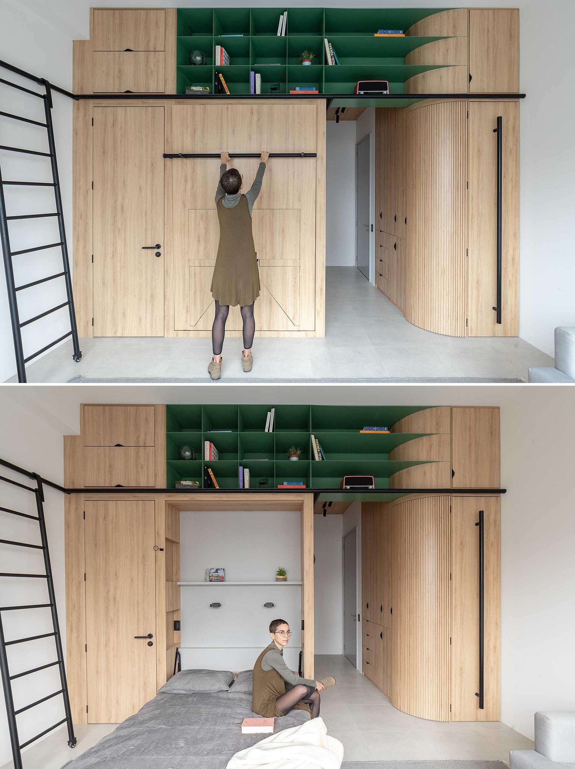 The minimalist wood cabinets in this studio apartment include a variety of hidden features, like a fold down bed. Once lowered, shelves behind and to the side of the bed are revealed.