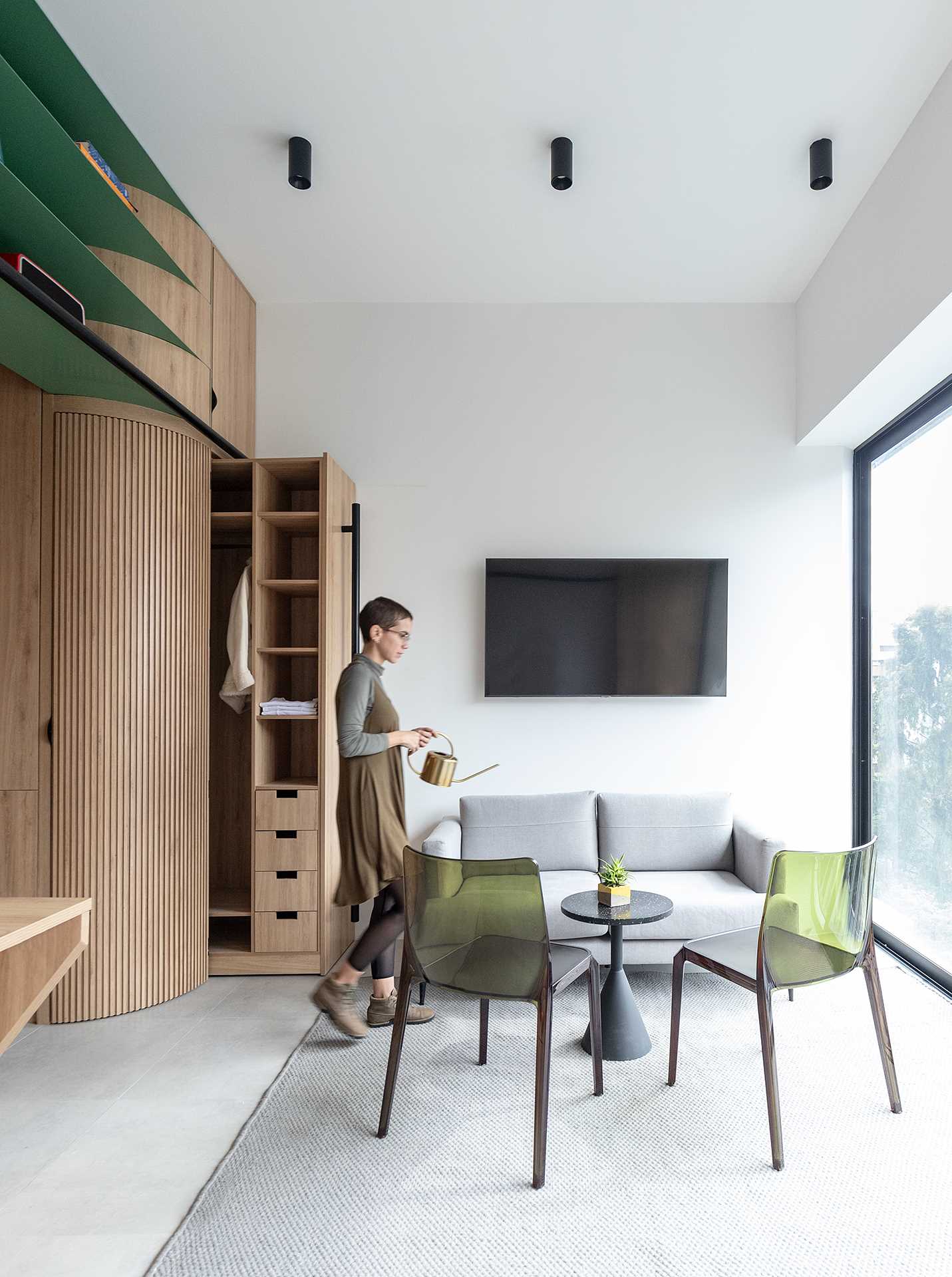 A hidden closet slides out to reveal drawers, shelves, and an space to hang clothes.