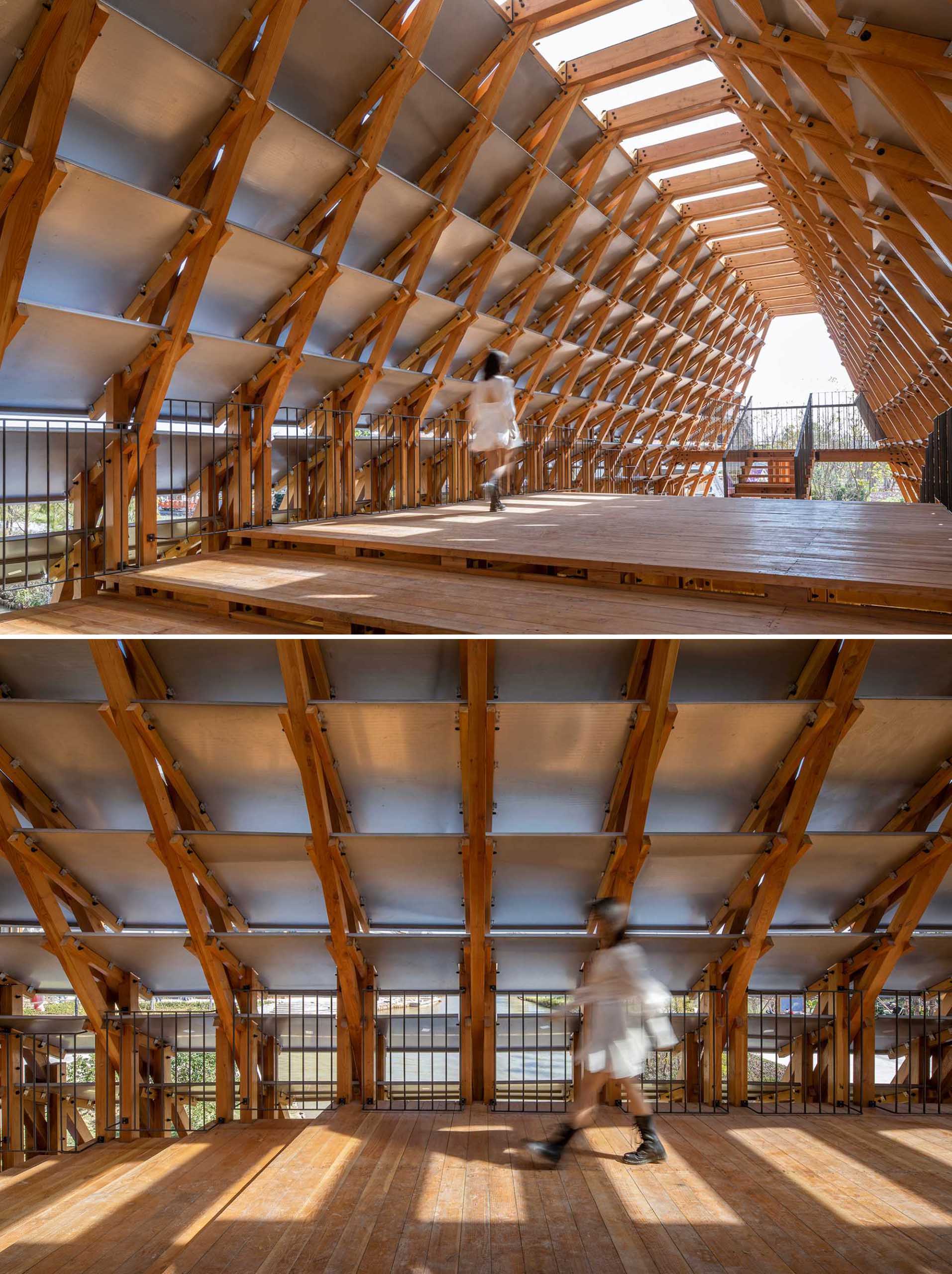 A pedestrian bridge built from wood has metal plates on its exterior.