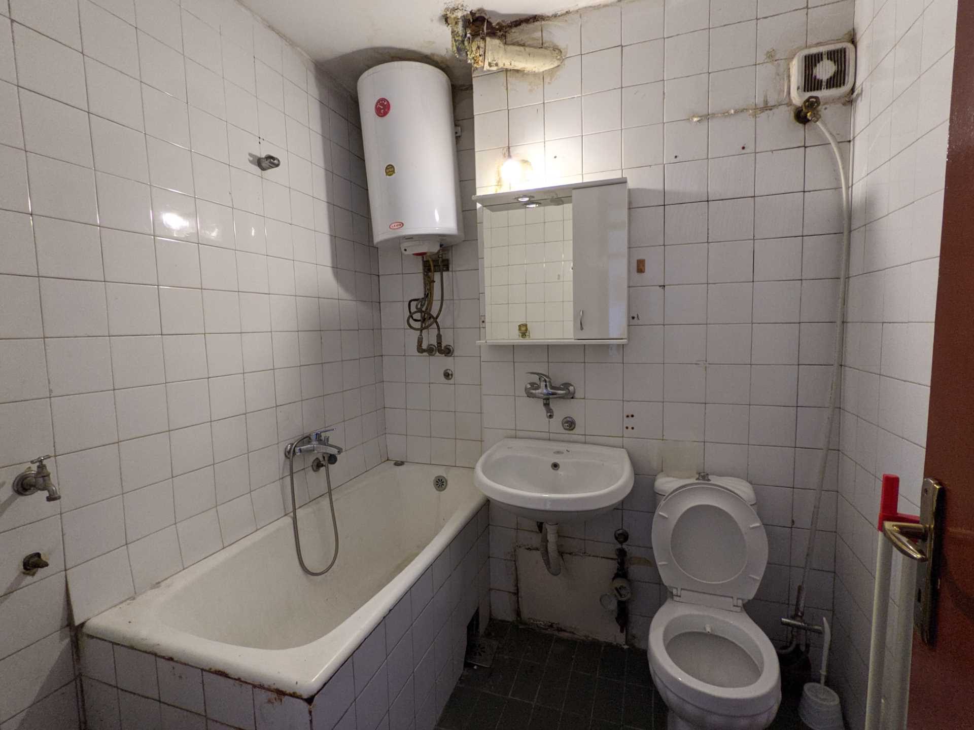 BEFORE - A dated 1960's apartment bathroom was completely gutted before being transformed into an apartment full of color.