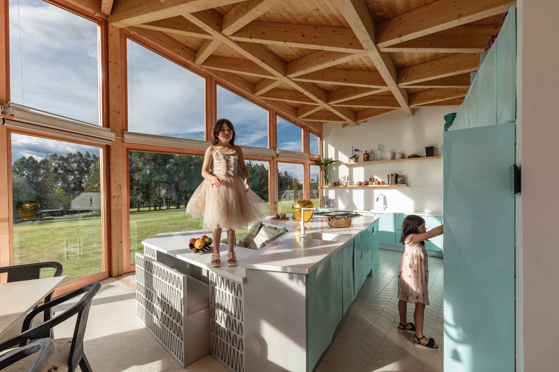 A contemporary kitchen design with an exposed wood ceiling.