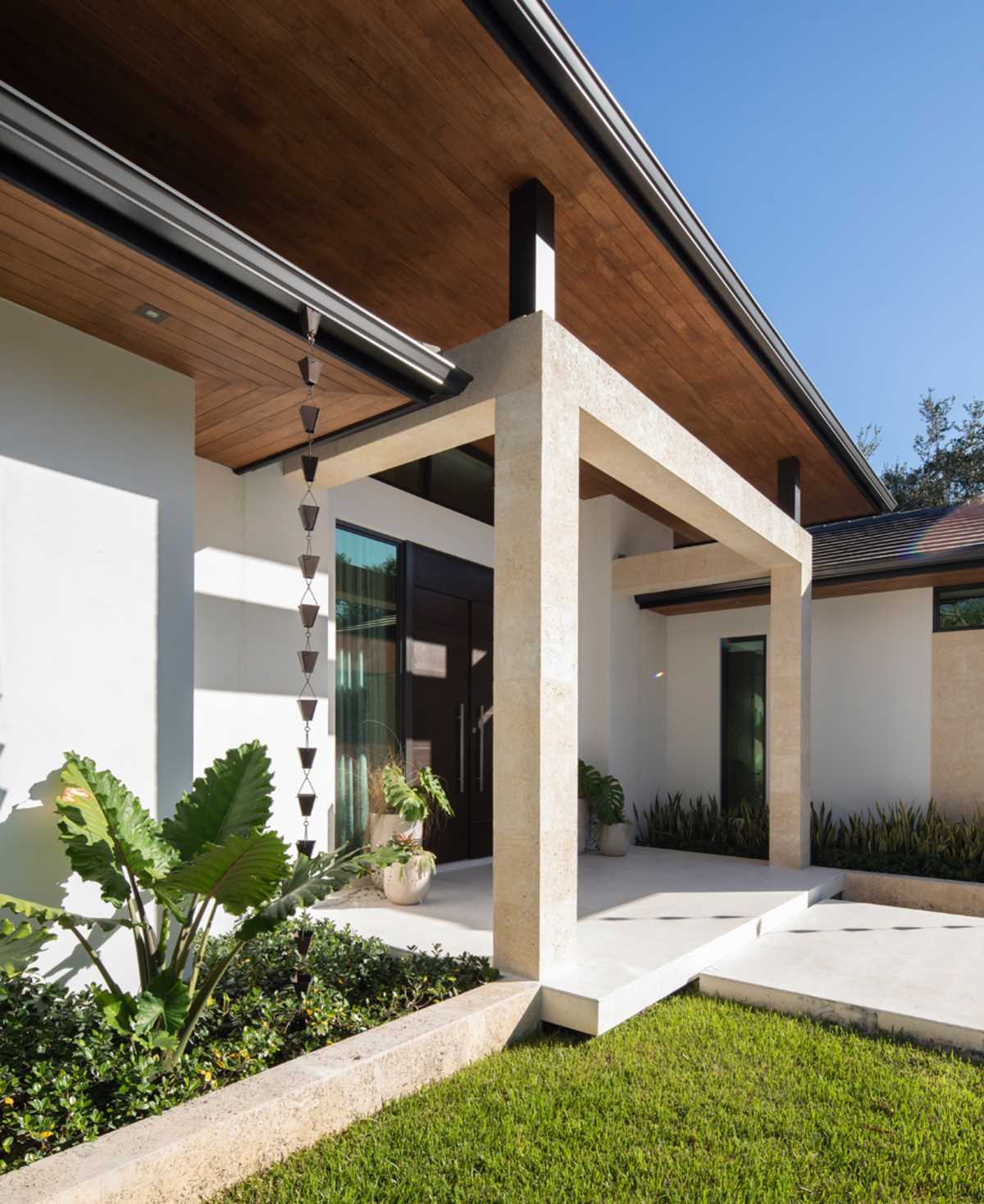 A contemporary home with rain chains.