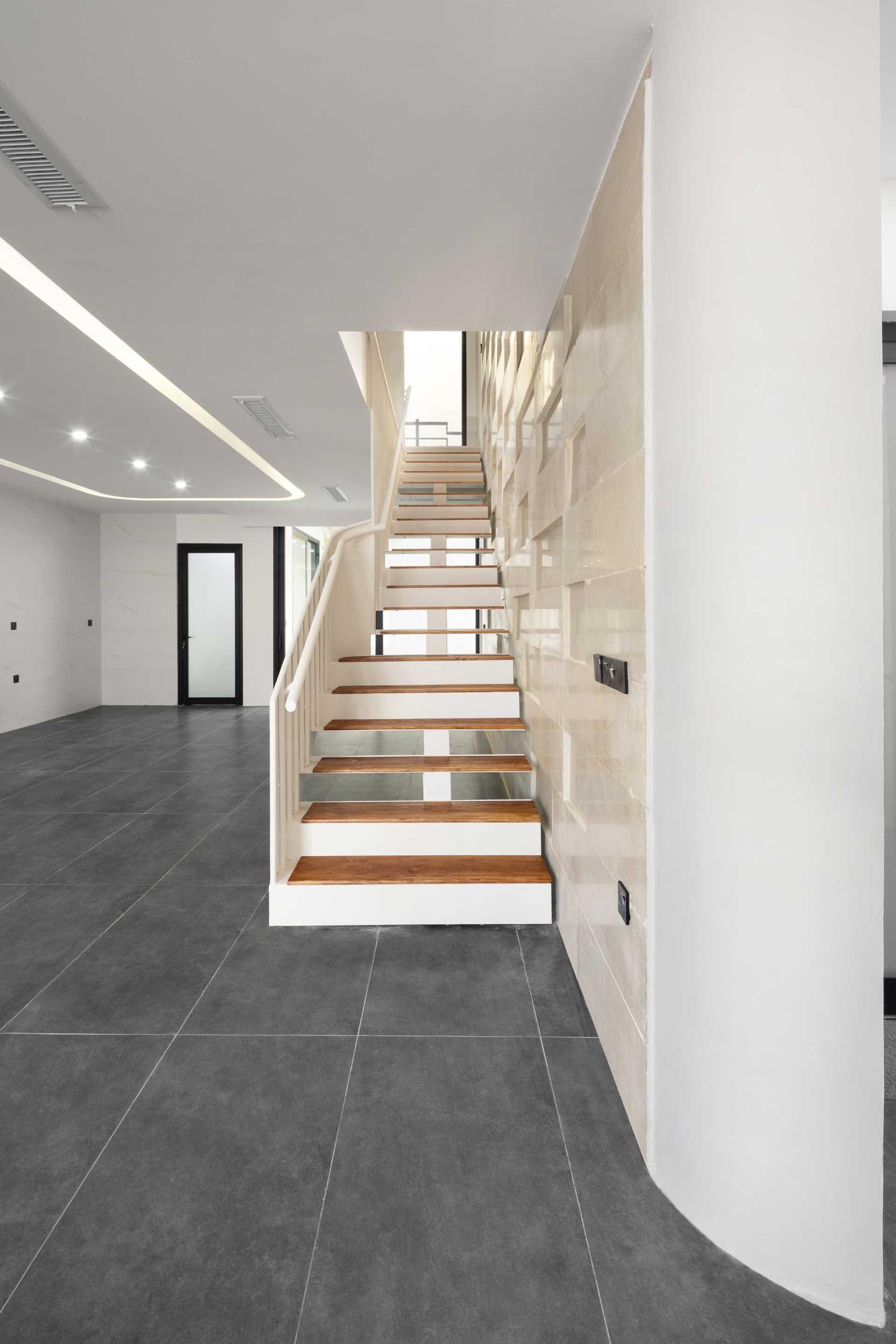 A modern house with large format grey floor tiles.