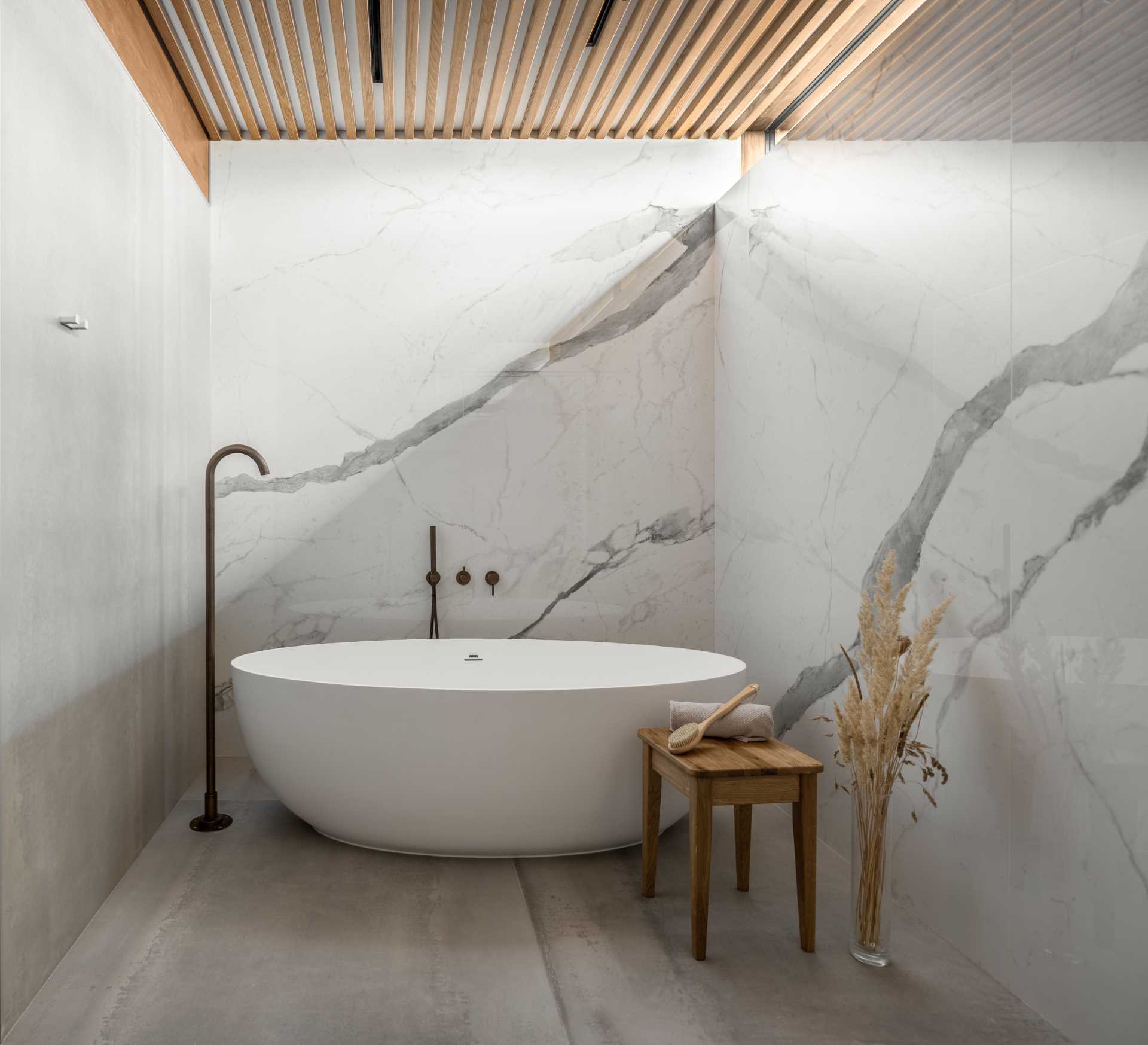 A modern bathroom design with a freestanding bathtub.