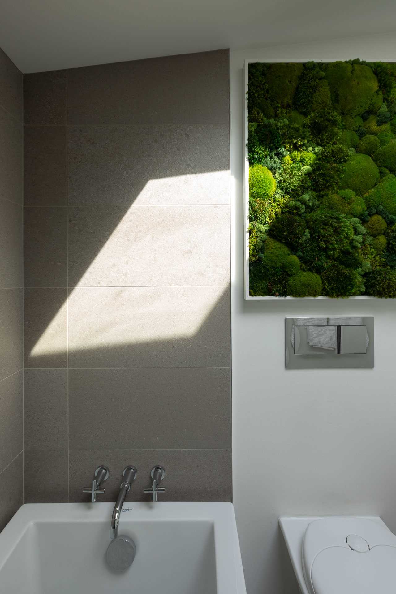 A modern bathroom with oversized tiles.
