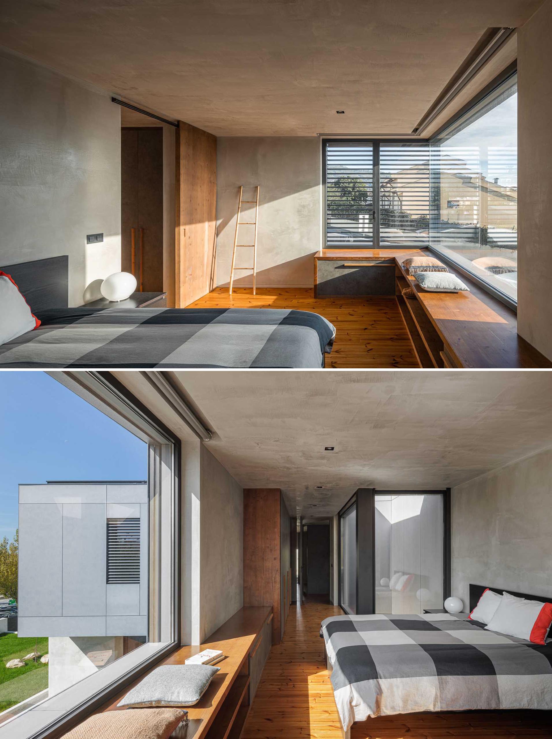 A modern bedroom with a corner window bench.