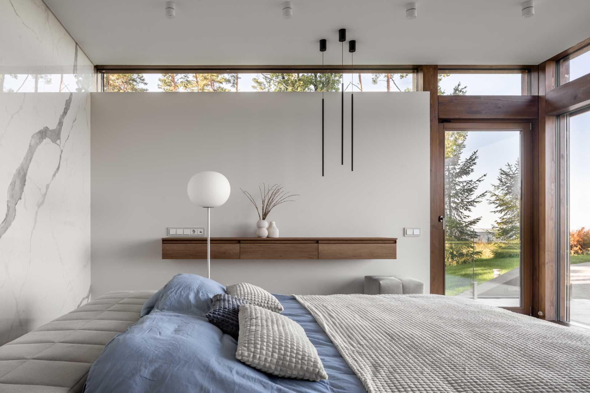 A modern bedroom with a floating wood shelf.