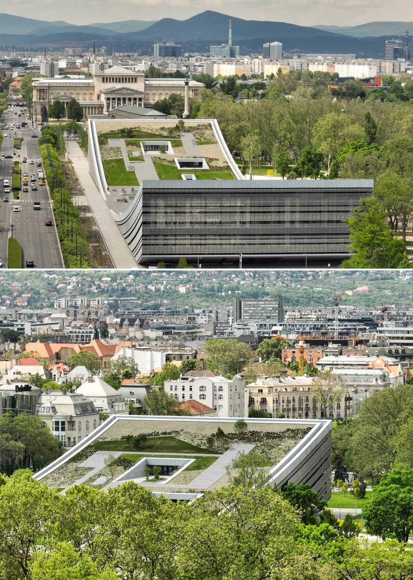 A modern building with a curved green roof includes grass, plants, and steps.