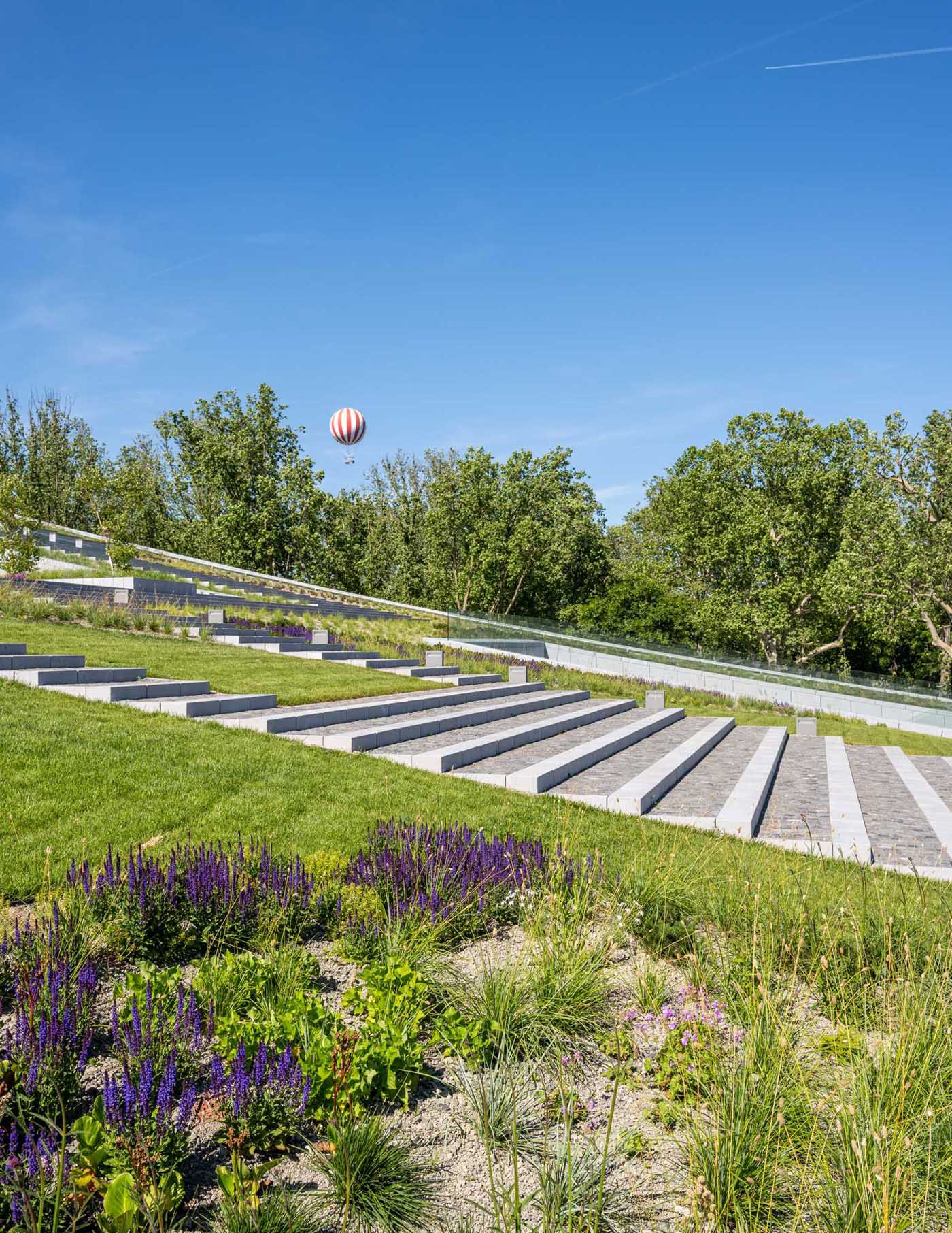 A modern building with a curved green roof.