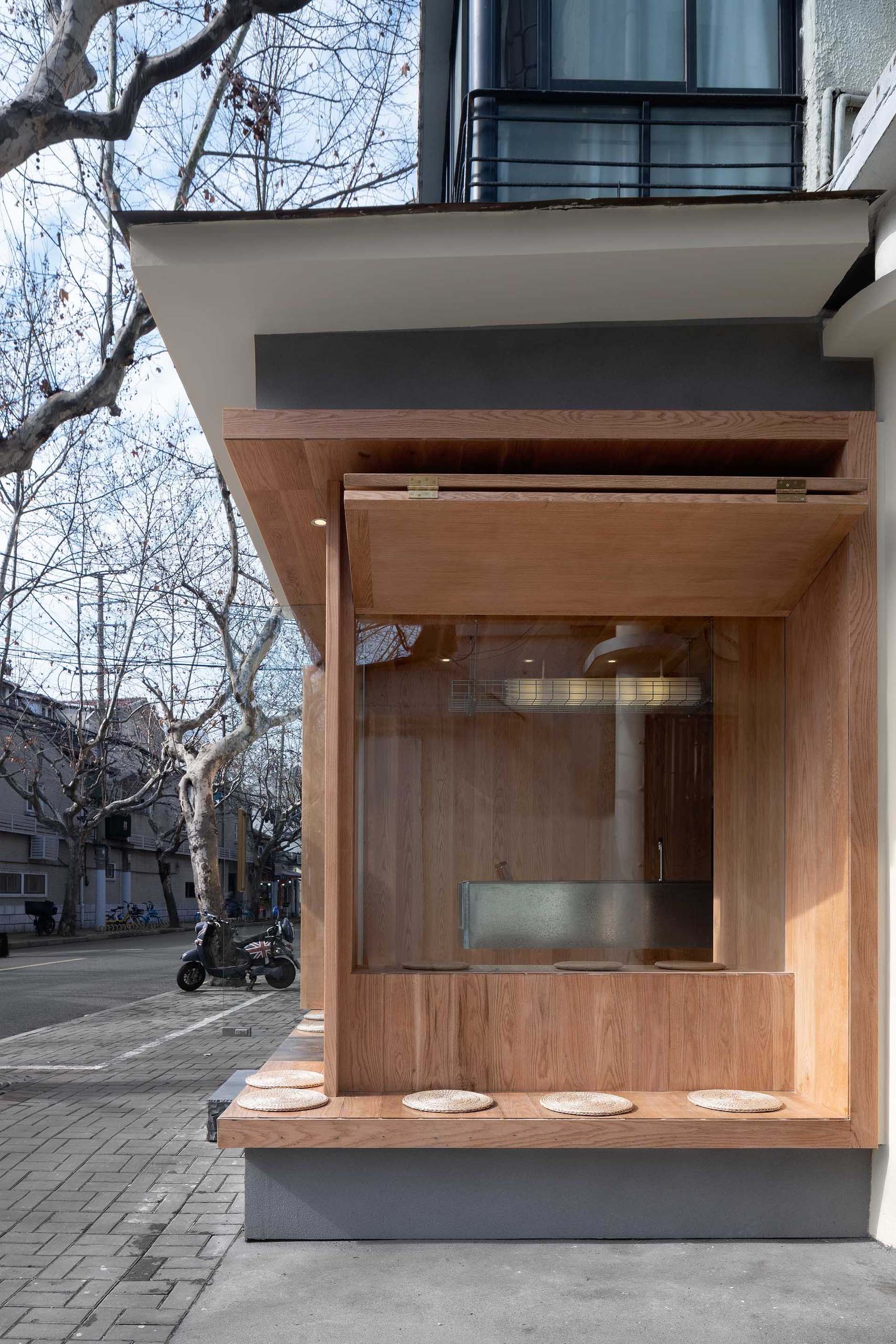 A modern coffee shop with built-in outdoor seating.