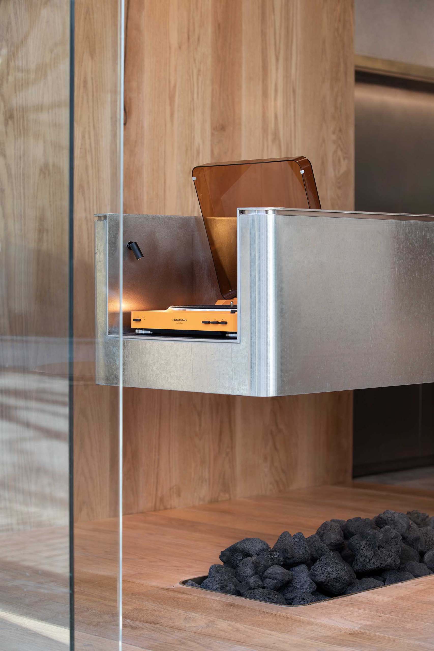 A modern coffee shop has a record player built into the counter.