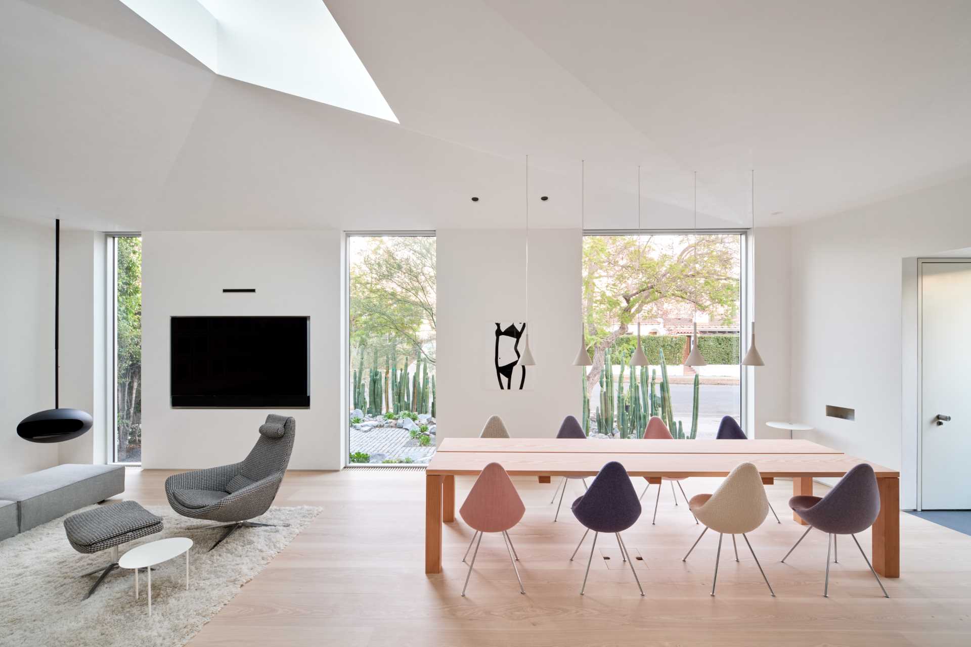 This open plan dining area includes a custom design table made from Douglas Fir planks with a whitewash finish.