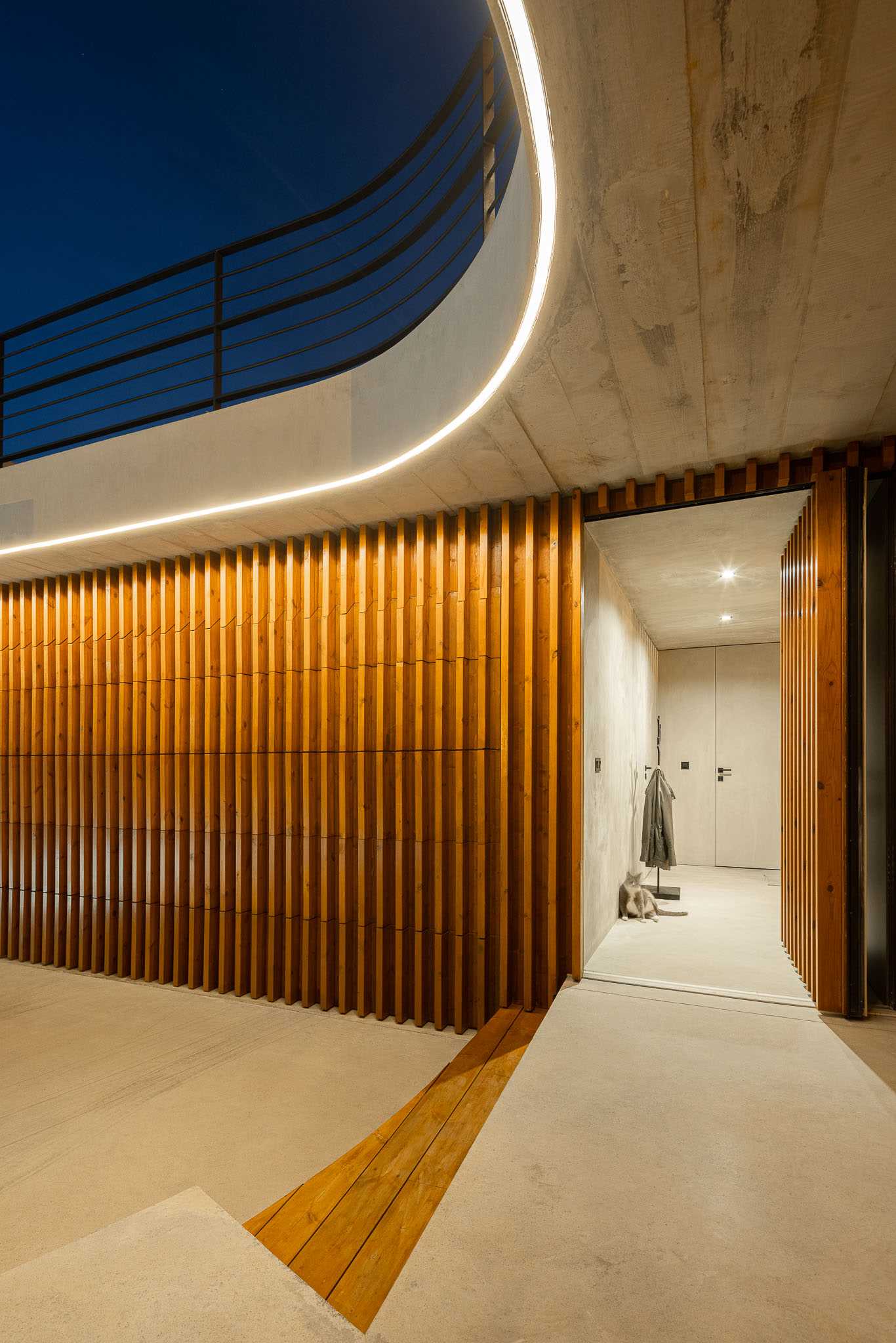 A modern house with a wood accent and hidden garage door.